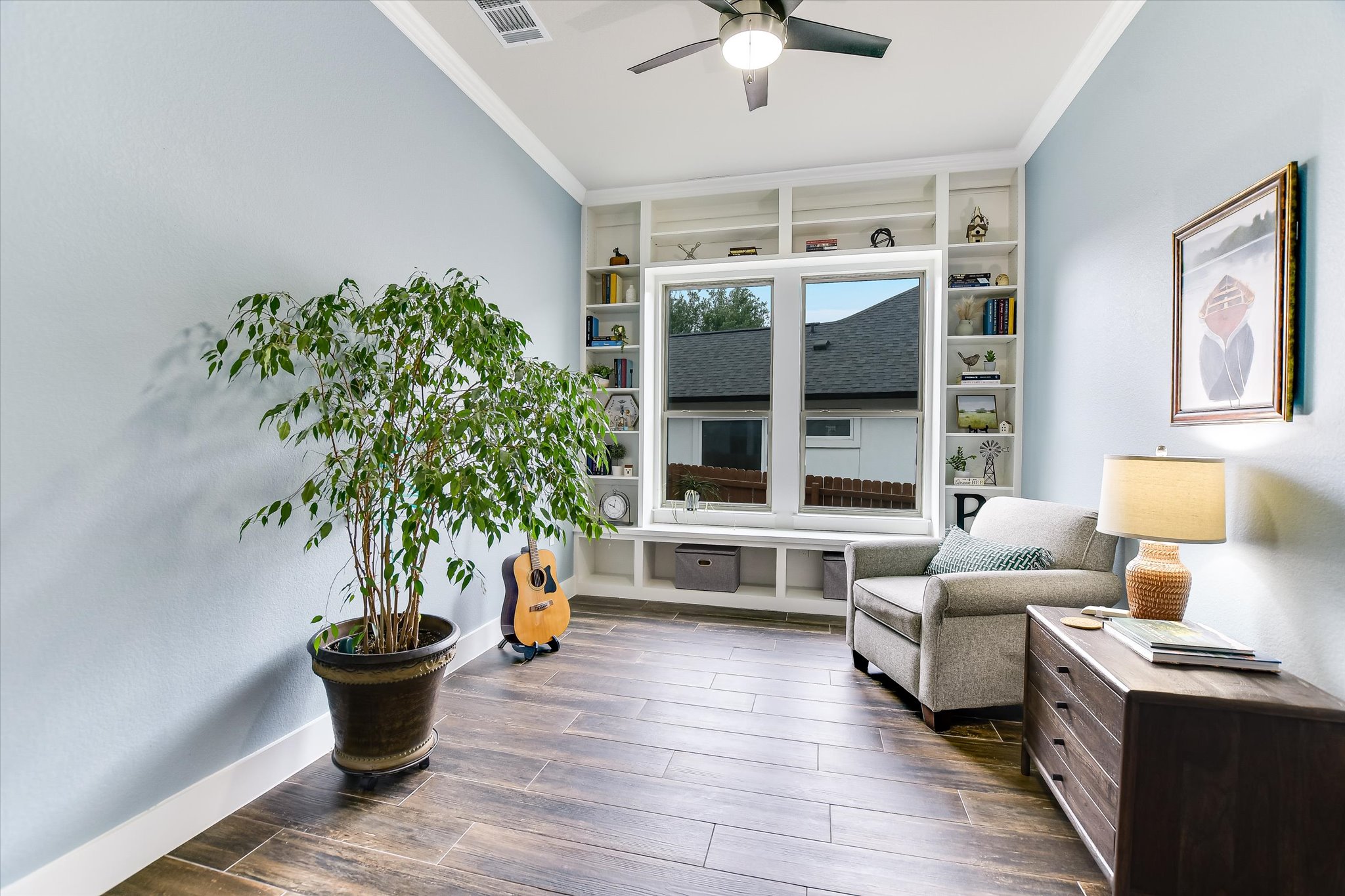 332 Axis Loop Georgetown, TX 78628 - Photo 23 of 37 Sitting room featuring wood tiled floors, a ceiling fan, and custom shelving