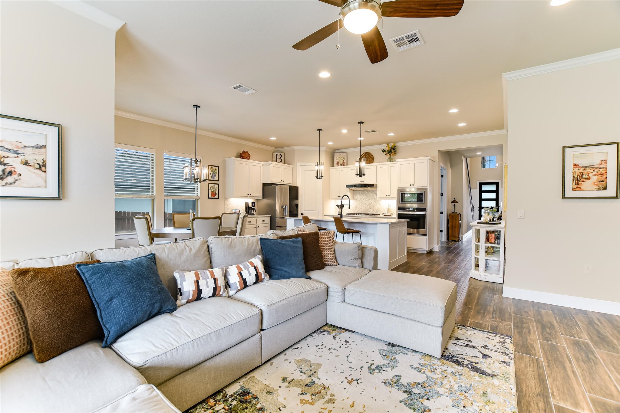 332 Axis Loop Georgetown, TX 78628 - Photo 9 of 37 Living room with a ceiling fan, dark wood-type flooring, ornamental molding, and recessed lighting