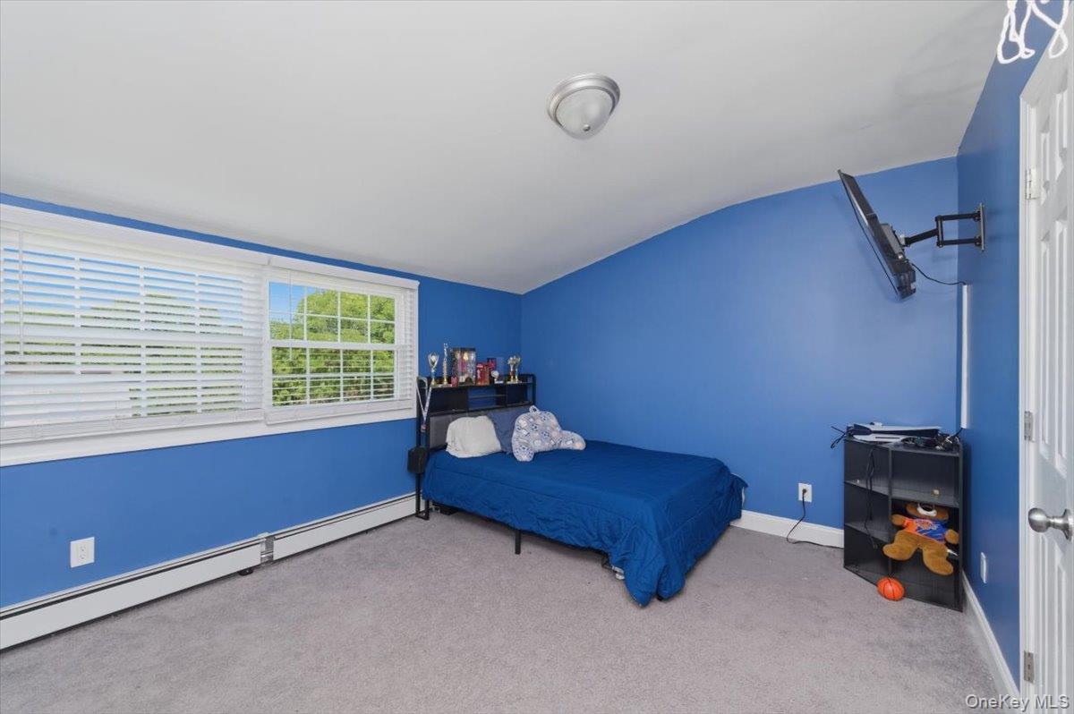 10 Rutgers Road Farmingville, NY 11738 - Photo 16 of 27 a room with furniture and a window