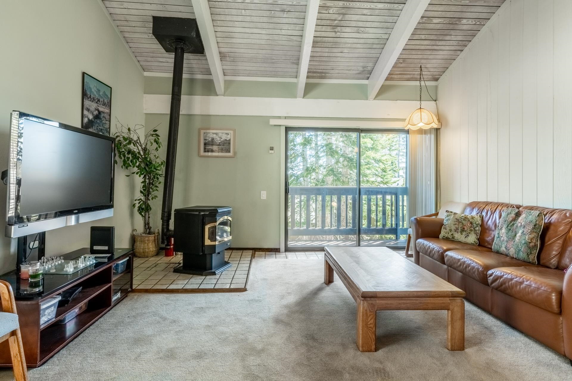 94 John Muir Road, Unit 132 Mammoth Lakes, CA 93546 - Photo 5 of 58 a living room with furniture and a flat screen tv