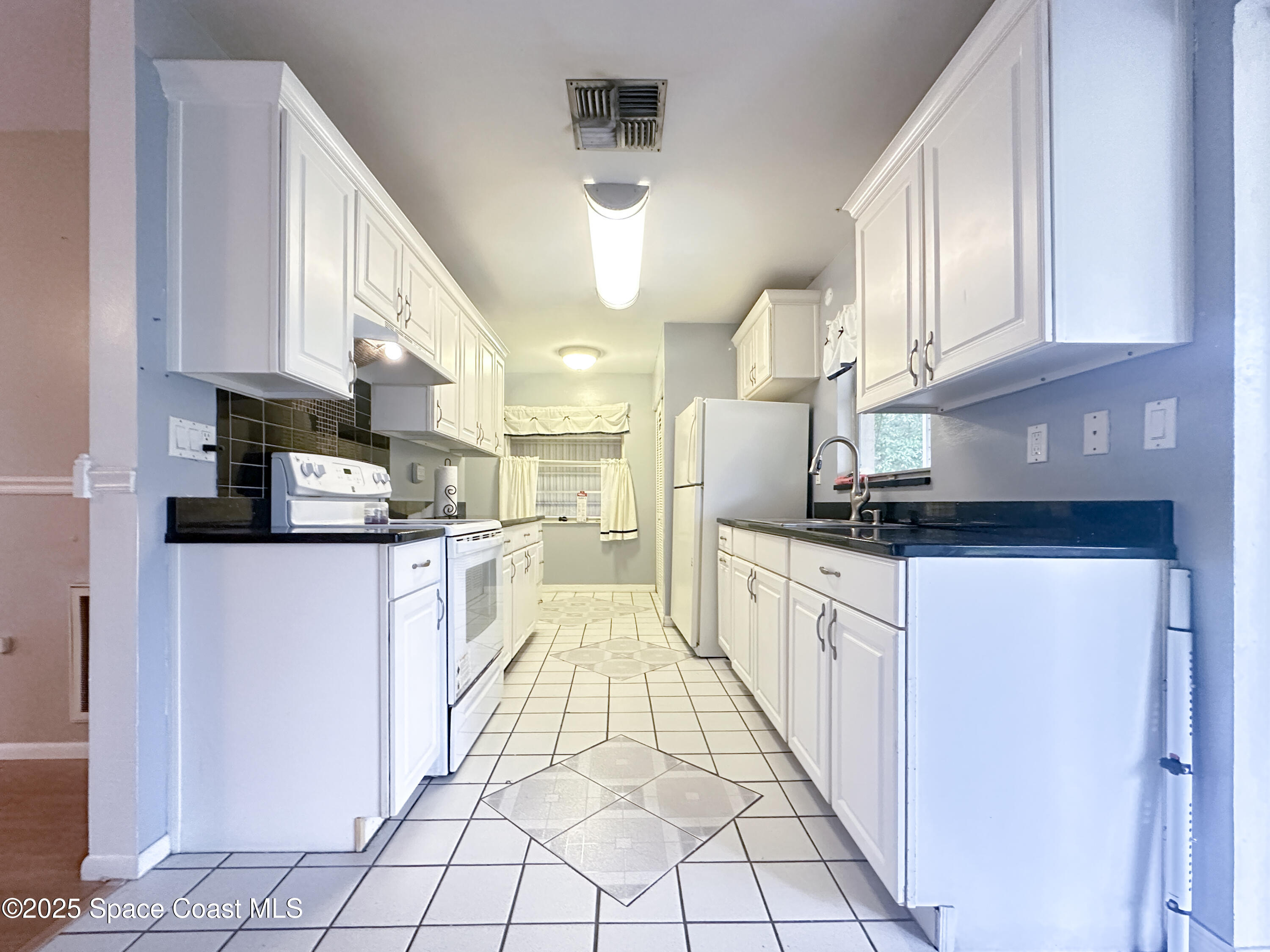 8215 Autumn Oak Avenue Port Richey, FL 34668 - Photo 12 of 21 a kitchen with stainless steel appliances granite countertop a refrigerator sink and cabinets