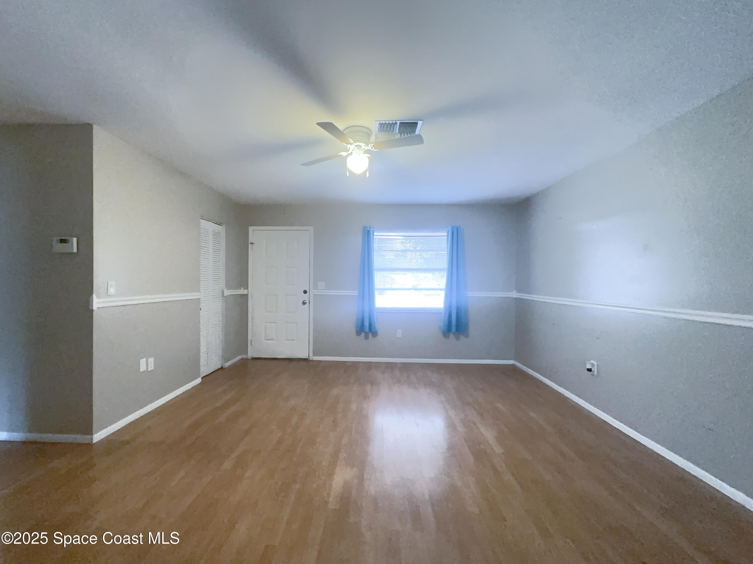 8215 Autumn Oak Avenue Port Richey, FL 34668 - Photo 13 of 21 a view of empty room with wooden floor and fan