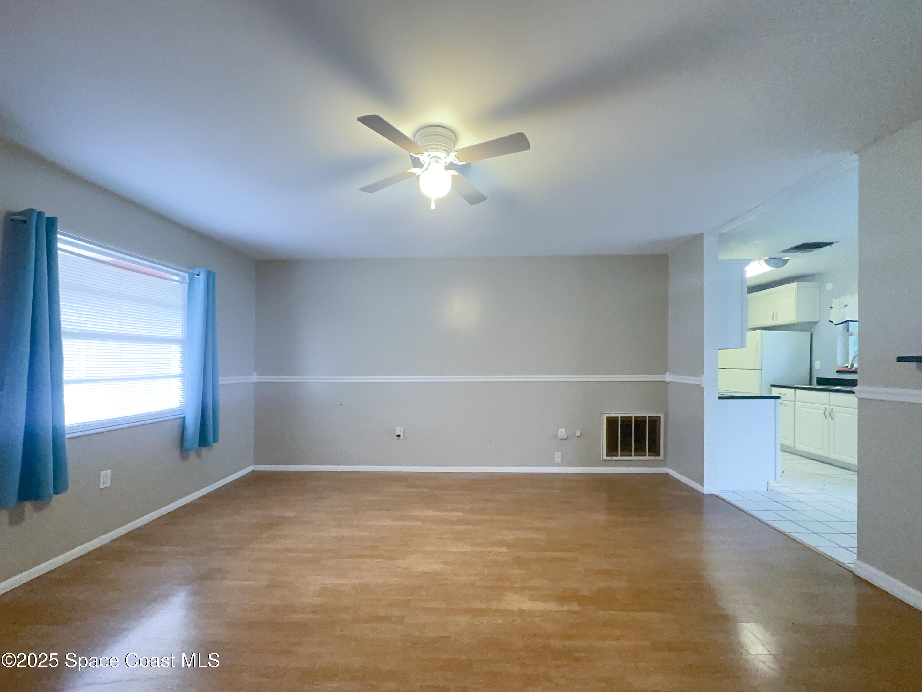 8215 Autumn Oak Avenue Port Richey, FL 34668 - Photo 14 of 21 a view of empty room with wooden floor and fan