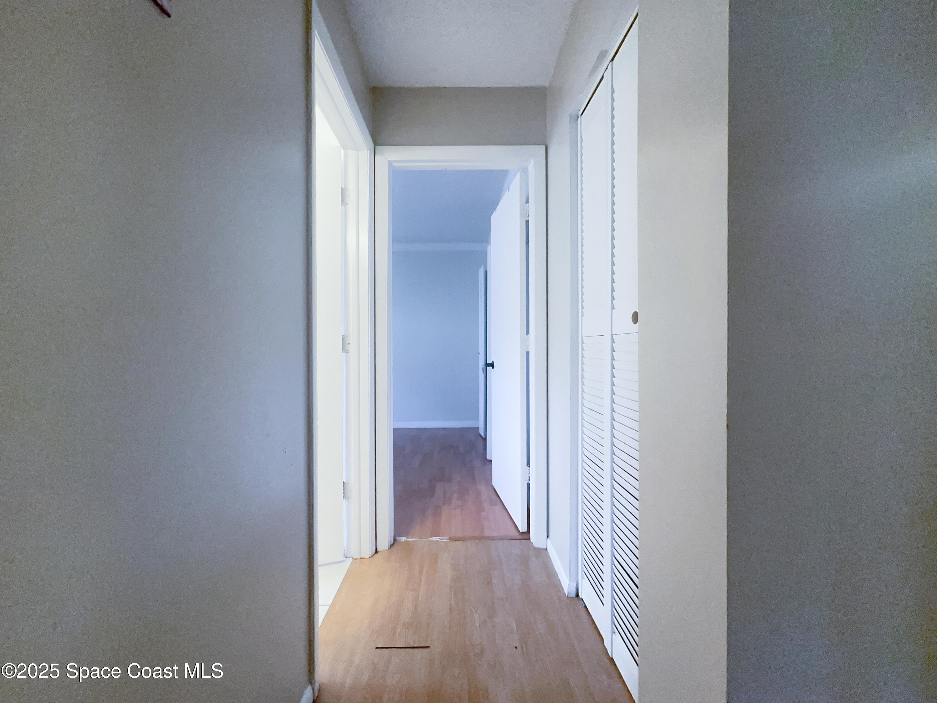 8215 Autumn Oak Avenue Port Richey, FL 34668 - Photo 15 of 21 a view of a hallway with wooden floor