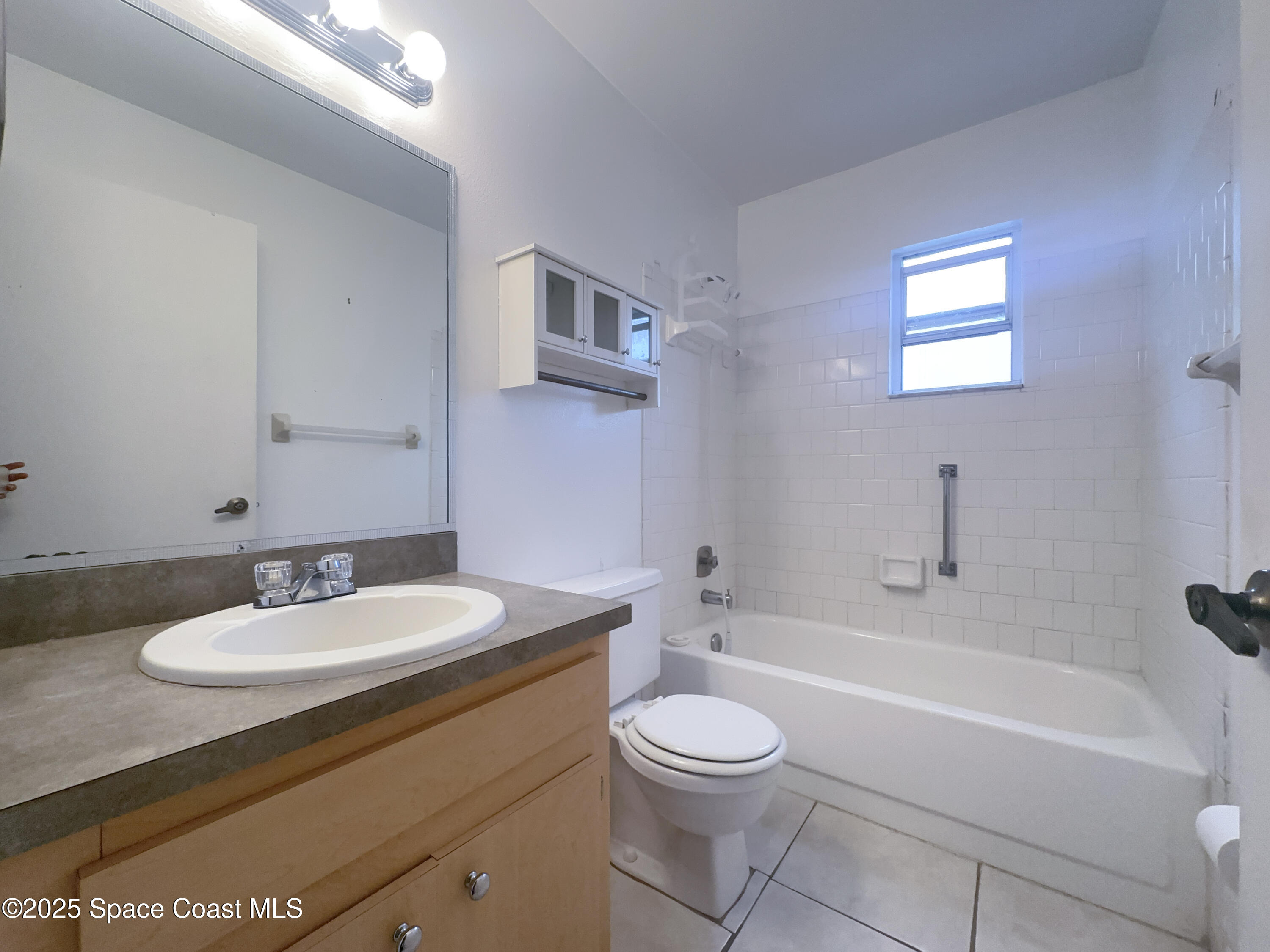 8215 Autumn Oak Avenue Port Richey, FL 34668 - Photo 16 of 21 a bathroom with a sink a toilet and a bathtub