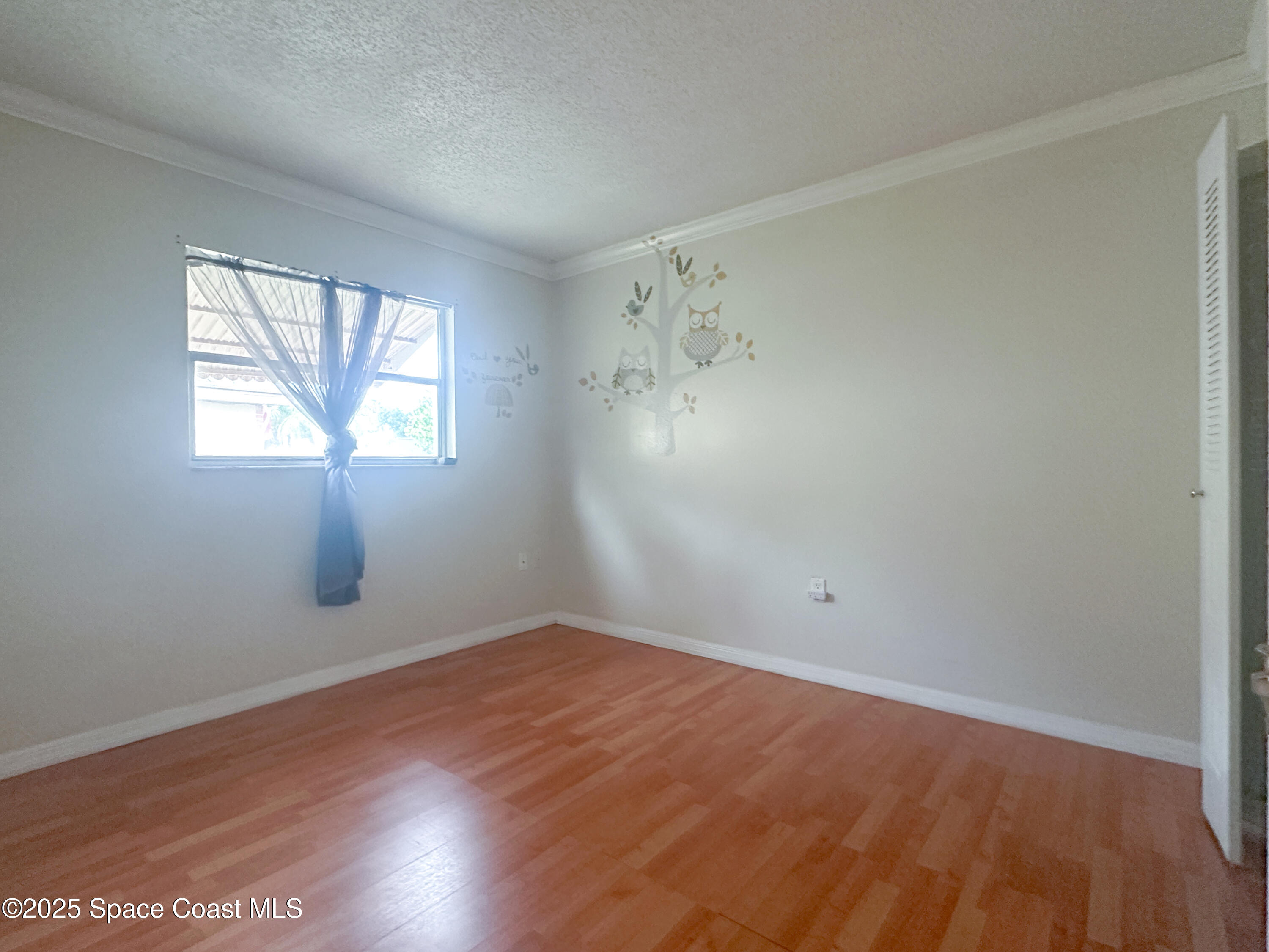 8215 Autumn Oak Avenue Port Richey, FL 34668 - Photo 21 of 21 an empty room with wooden floor and windows