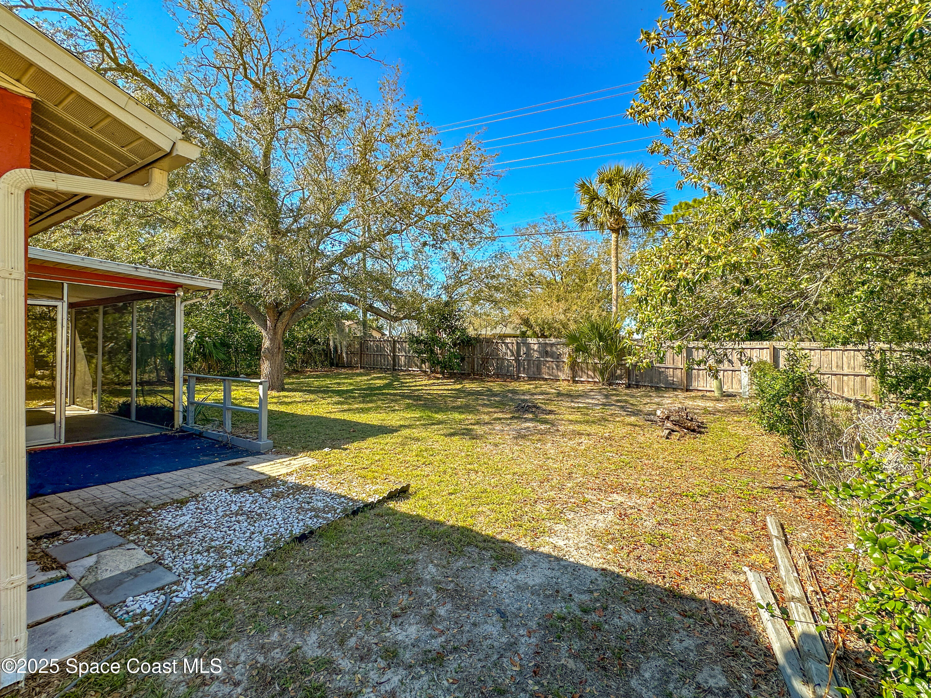 8215 Autumn Oak Avenue Port Richey, FL 34668 - Photo 6 of 21 a view of a swimming pool with a lawn chairs under an umbrella
