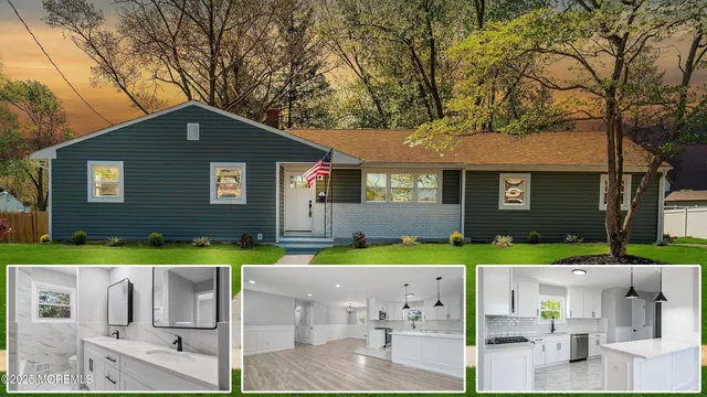 a front view of a house with a yard and trees