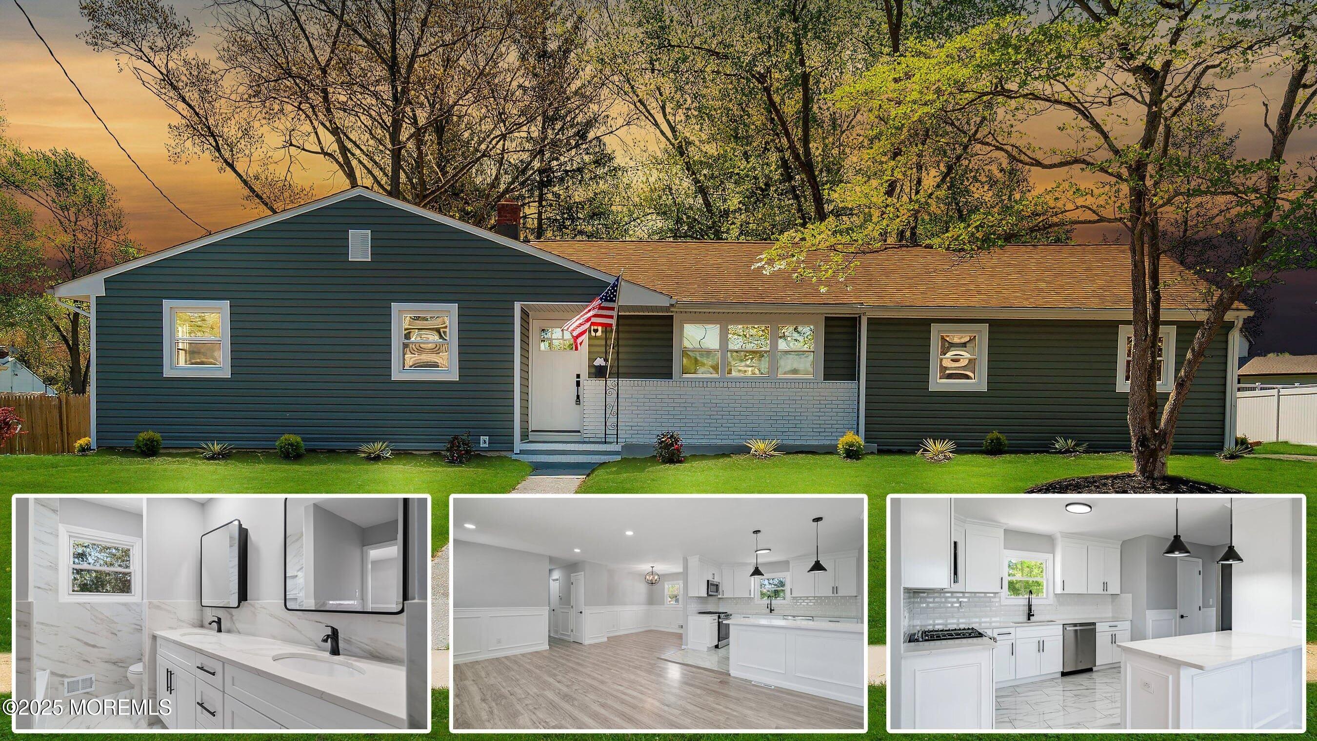 a front view of a house with a yard and trees