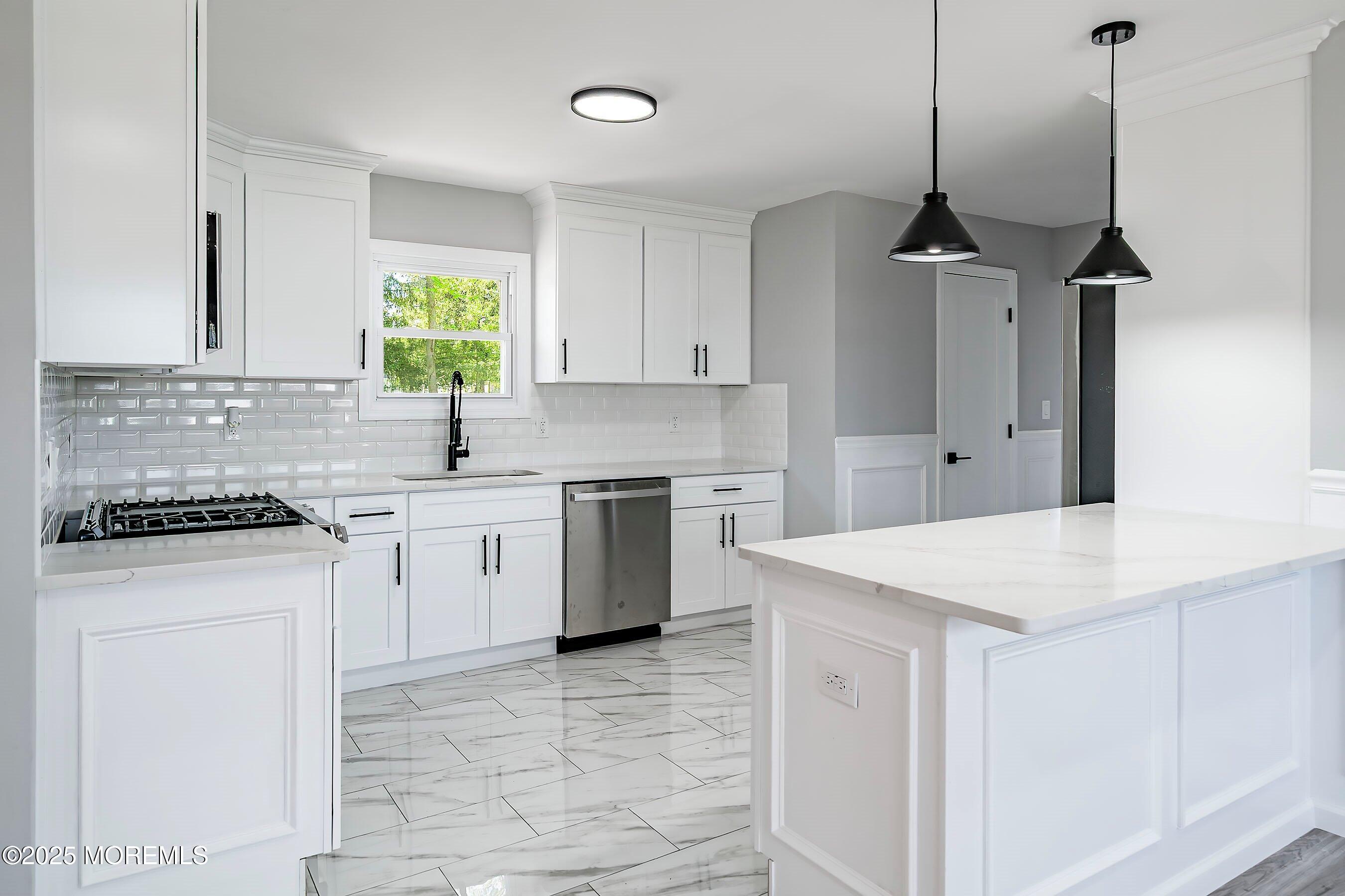 15 Springhill Drive Howell, NJ 07731 - Photo 12 of 32 a kitchen with a stove a sink a island and windows