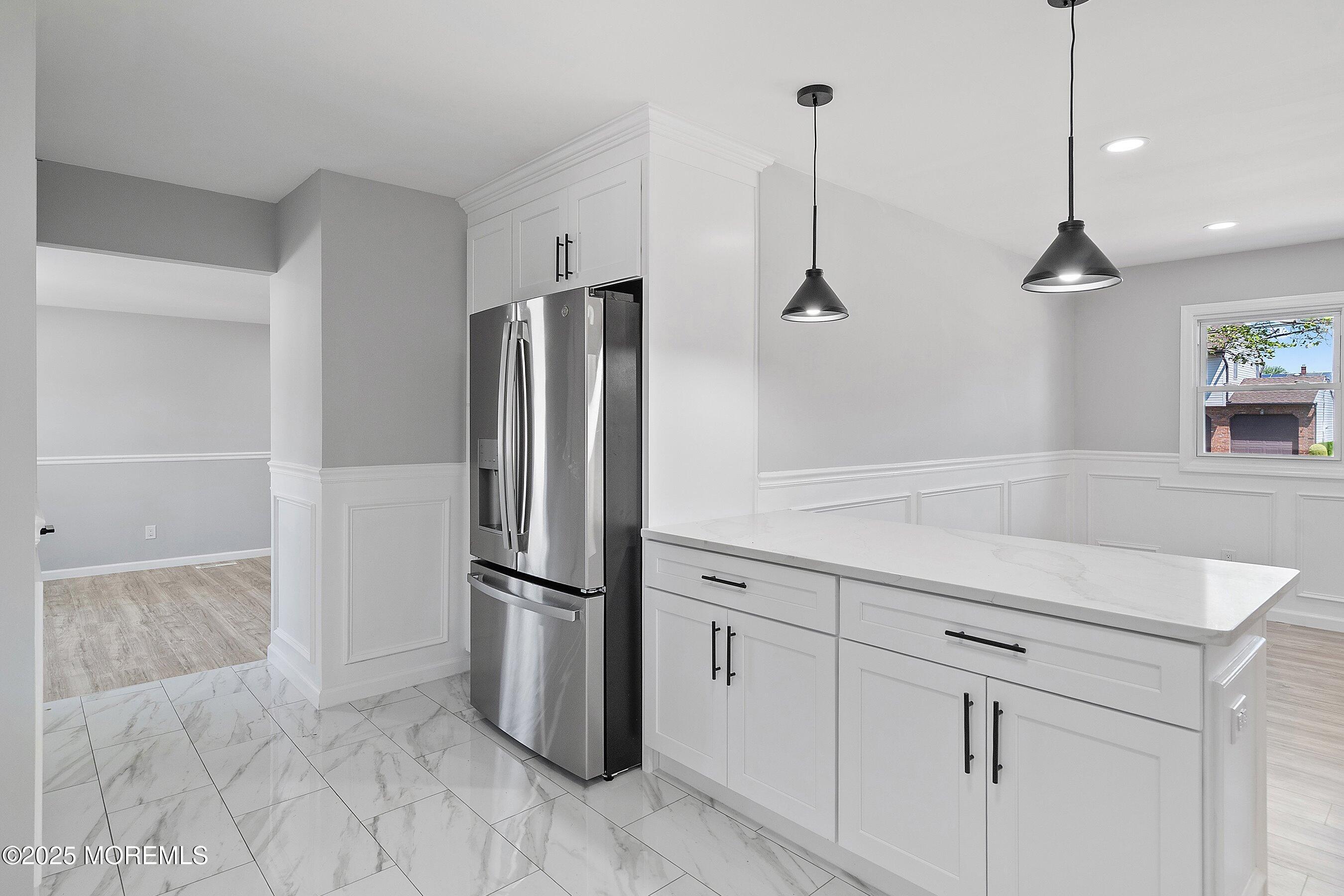 15 Springhill Drive Howell, NJ 07731 - Photo 13 of 32 a kitchen with kitchen island white cabinets and stainless steel appliances
