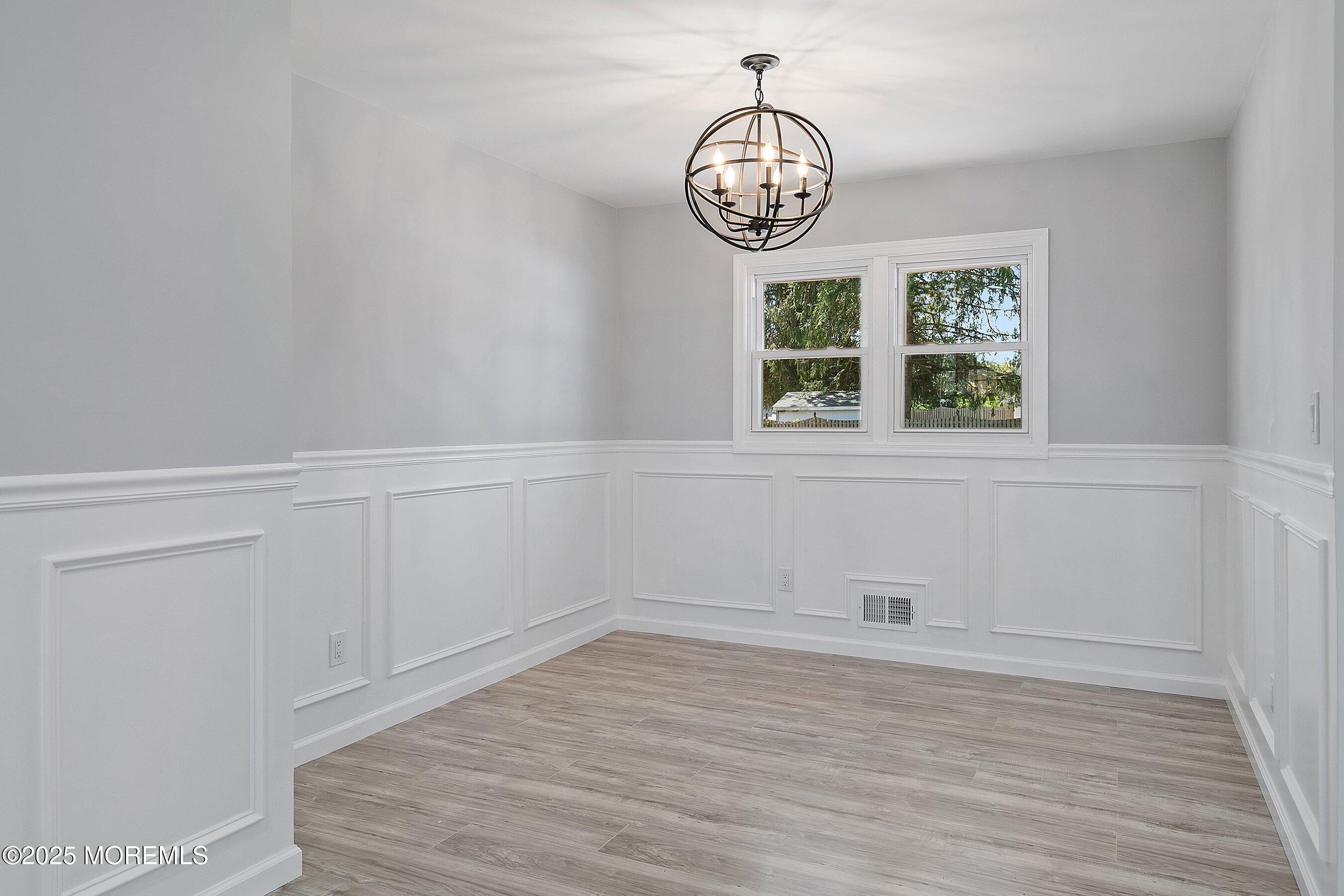 15 Springhill Drive Howell, NJ 07731 - Photo 7 of 32 wooden floor in an empty room with a window