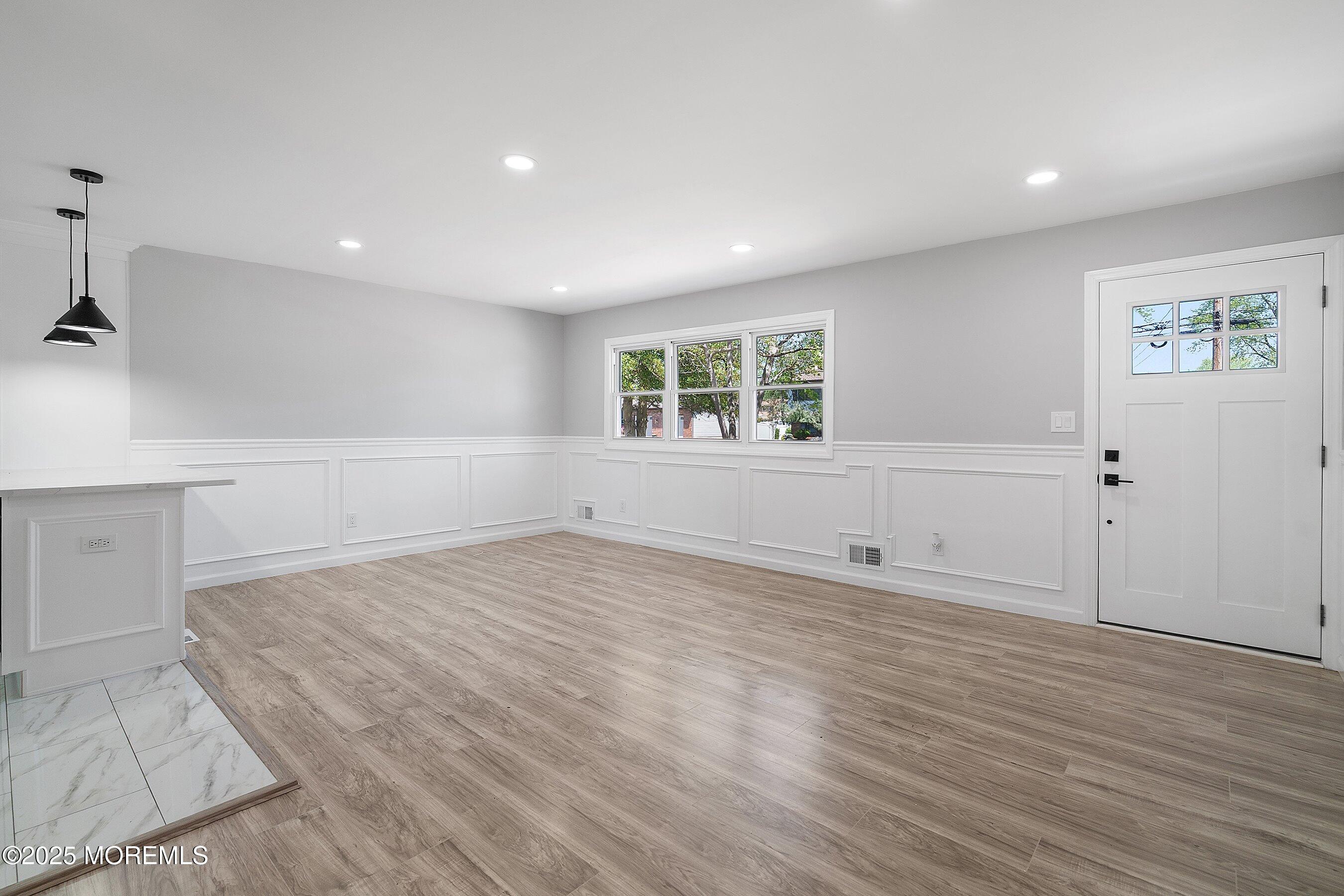15 Springhill Drive Howell, NJ 07731 - Photo 8 of 32 an empty room with wooden floor and windows
