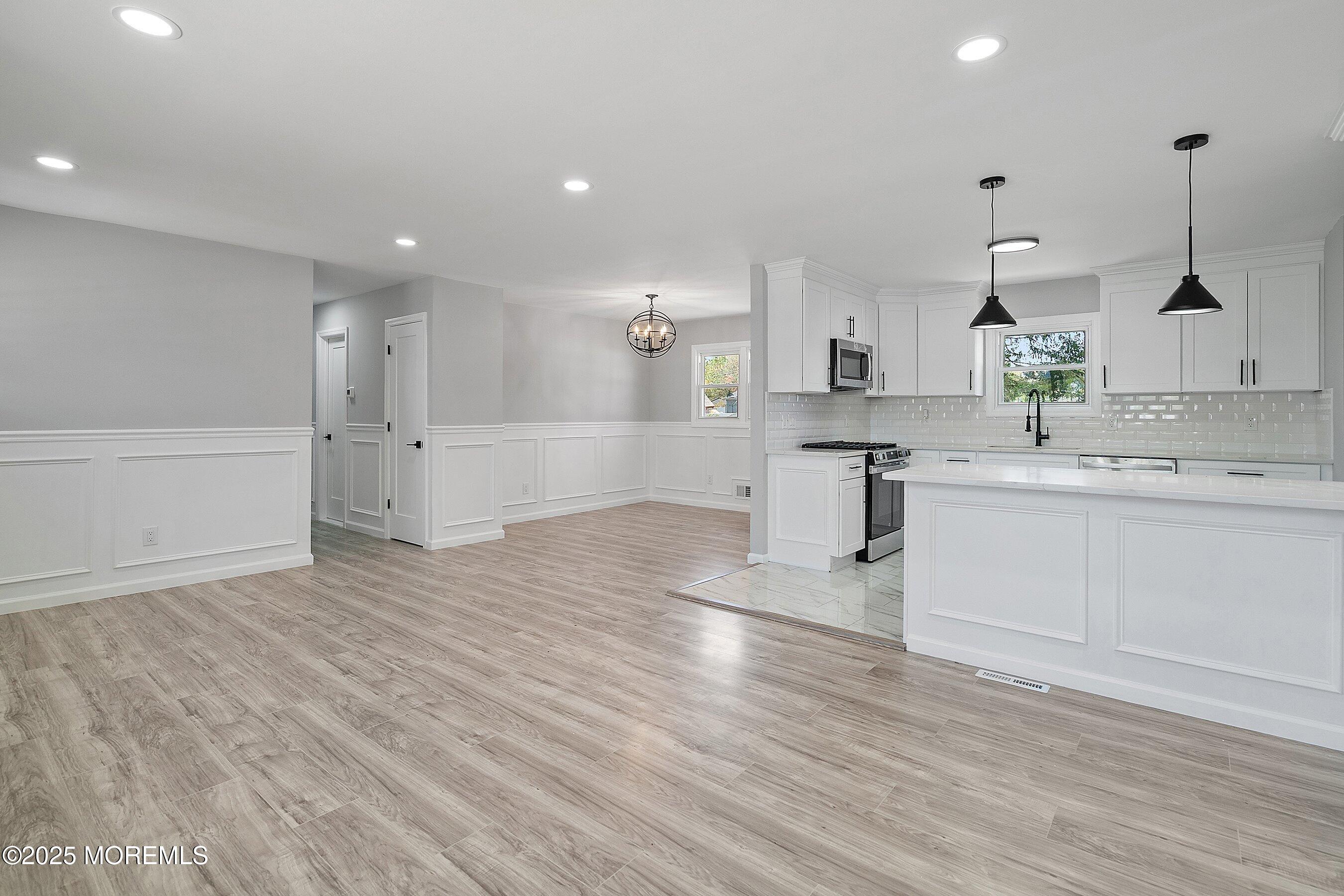 15 Springhill Drive Howell, NJ 07731 - Photo 10 of 32 a kitchen with a sink cabinets and wooden floor