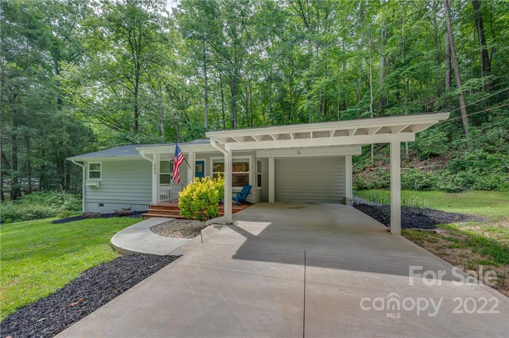 111 Jervey Road Tryon, NC 28782 - Photo 1 of 34 front view of a house with a yard and potted plants