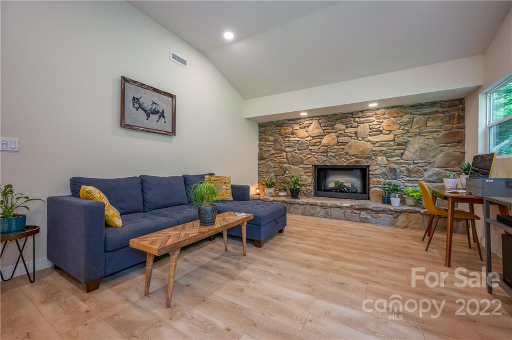 111 Jervey Road Tryon, NC 28782 - Photo 12 of 34 a living room with furniture a large window and a fireplace