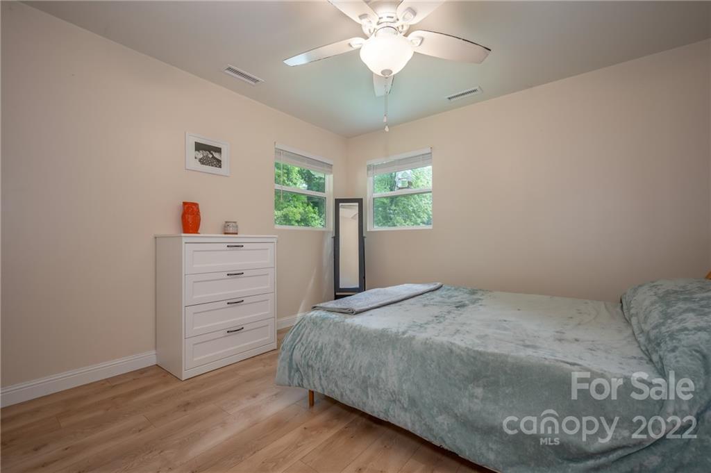 111 Jervey Road Tryon, NC 28782 - Photo 15 of 34 a bedroom with a bed and a dresser