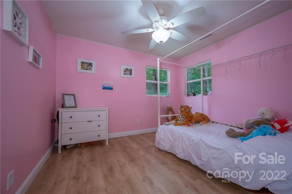 111 Jervey Road Tryon, NC 28782 - Photo 17 of 34 a bedroom with a bed and a dresser