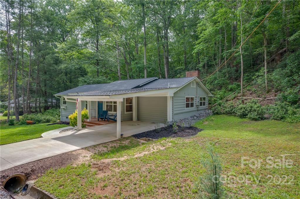 111 Jervey Road Tryon, NC 28782 - Photo 25 of 34 a view of a house with backyard and a garden