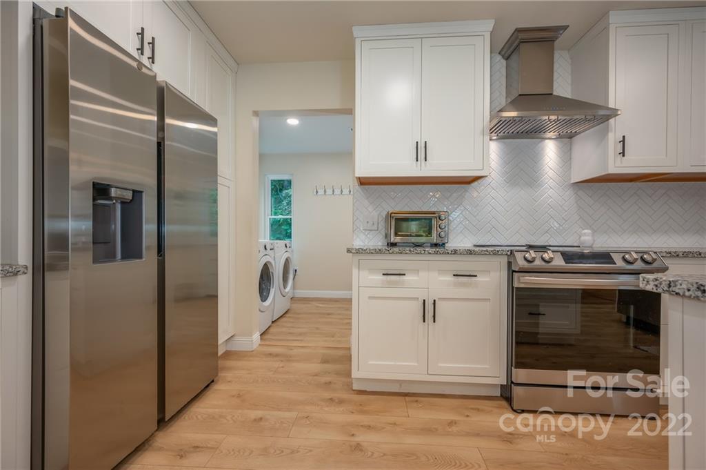 111 Jervey Road Tryon, NC 28782 - Photo 6 of 34 a kitchen with stainless steel appliances granite countertop a stove a refrigerator and a cabinets