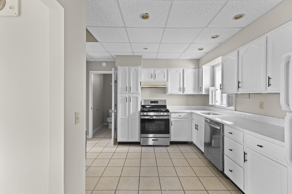 45 Garfield Street Fall River, MA 02721 - Photo 20 of 38 a kitchen with stainless steel appliances granite countertop a stove a sink and a refrigerator