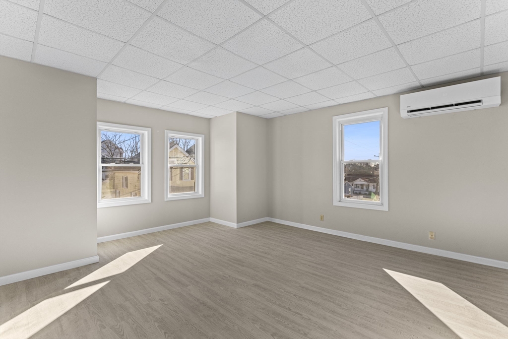 45 Garfield Street Fall River, MA 02721 - Photo 25 of 38 a view of an empty room with a window and wooden floor