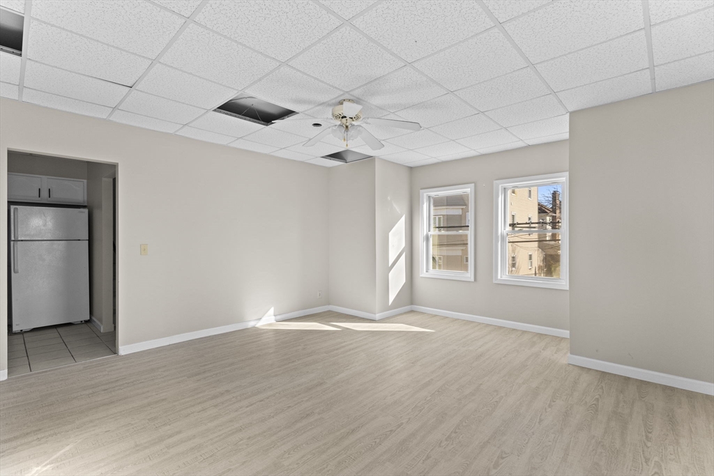 45 Garfield Street Fall River, MA 02721 - Photo 26 of 38 a view of an empty room with window and wooden floor