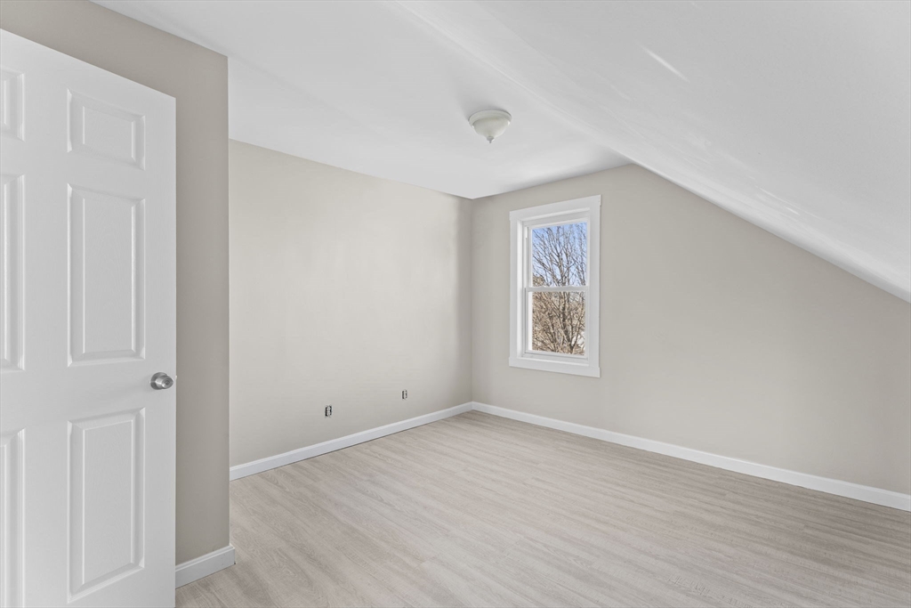 45 Garfield Street Fall River, MA 02721 - Photo 31 of 38 a view of an empty room with wooden floor and a window
