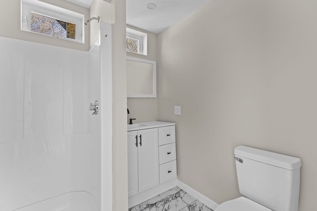 45 Garfield Street Fall River, MA 02721 - Photo 6 of 38 a bathroom with a toilet sink and vanity