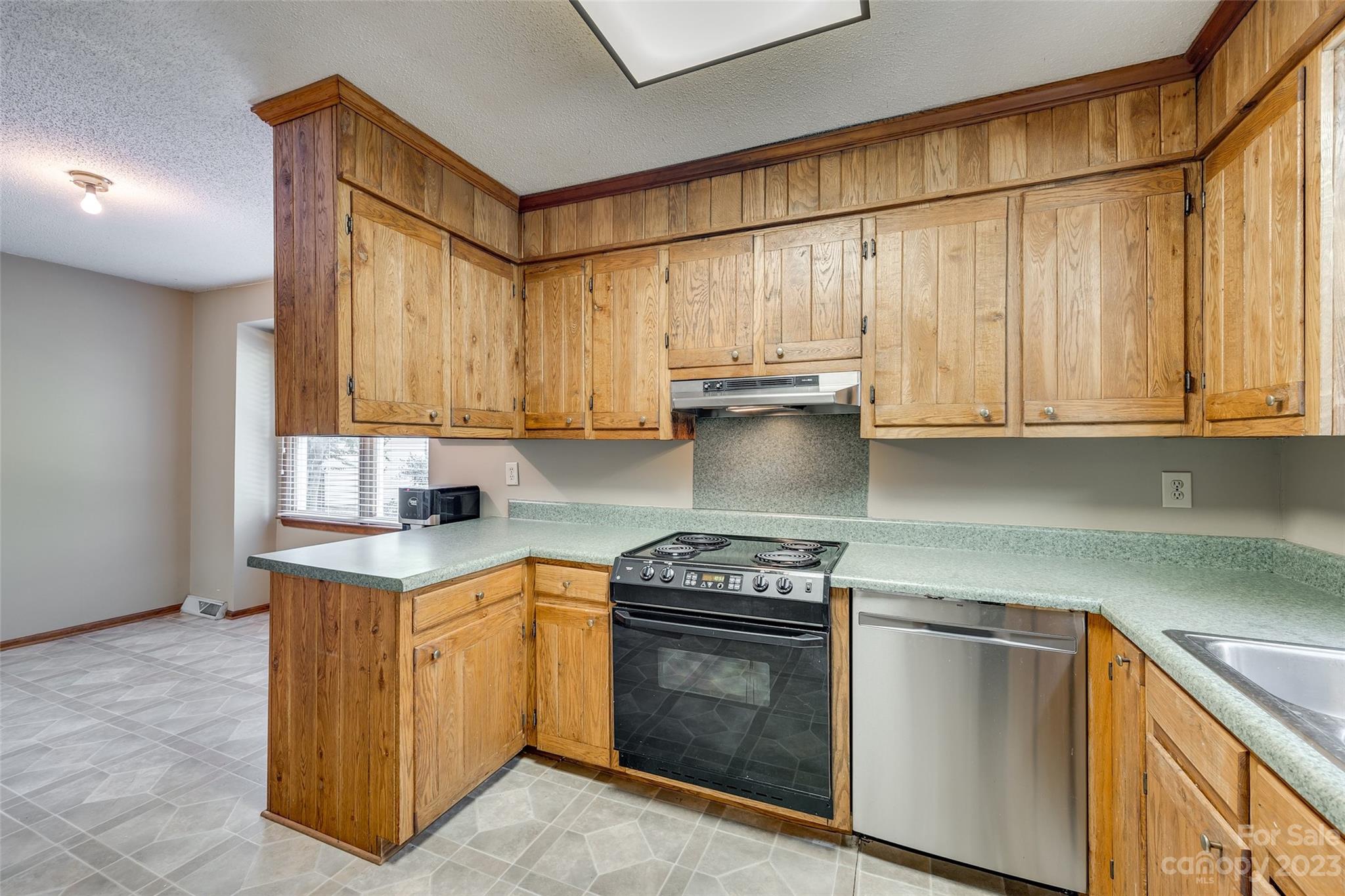 16064 Taku Court Tega Cay, SC 29708 - Photo 12 of 31 a kitchen with stainless steel appliances a stove a sink and cabinets