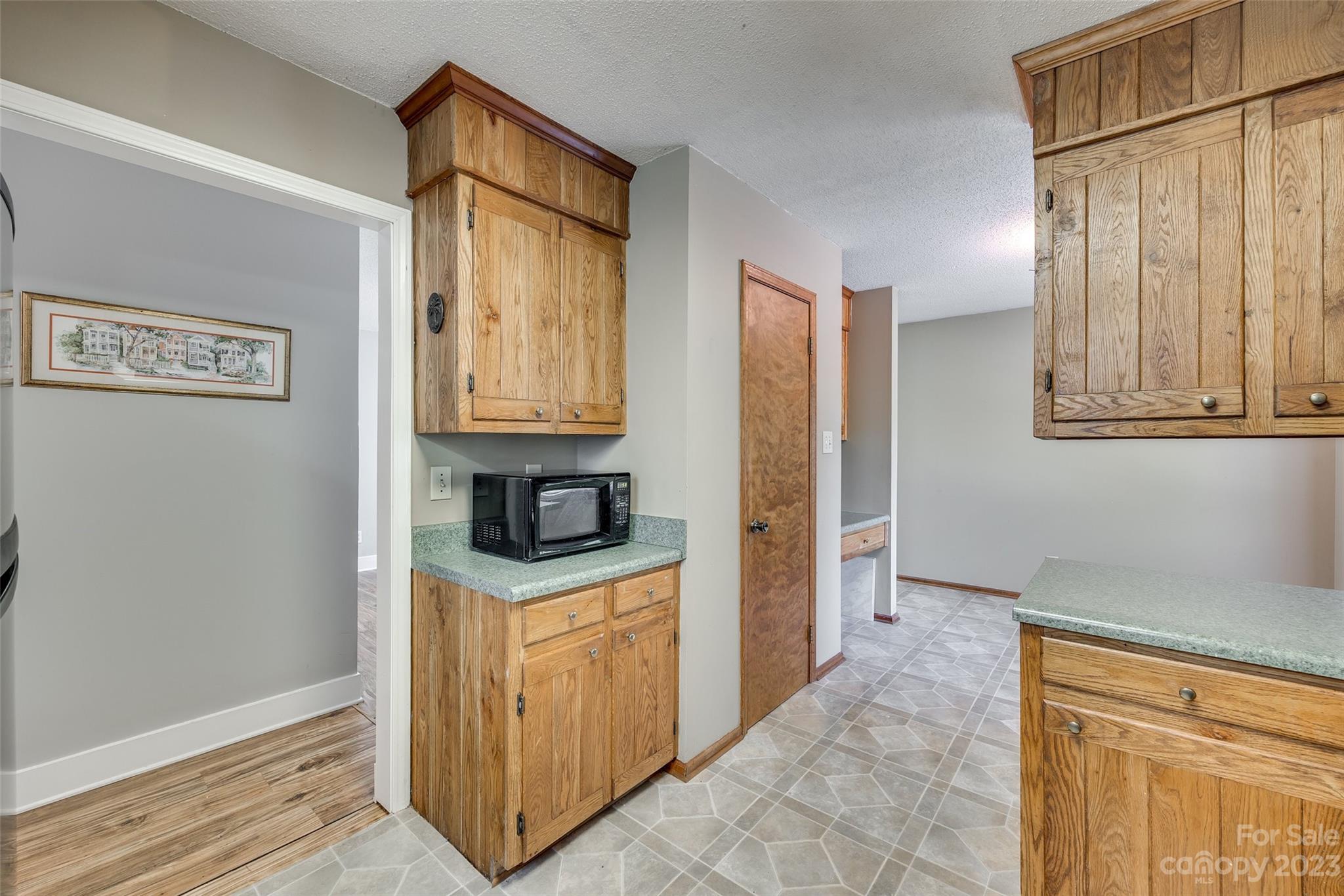 16064 Taku Court Tega Cay, SC 29708 - Photo 13 of 31 a view of kitchen with cabinets and wooden floor
