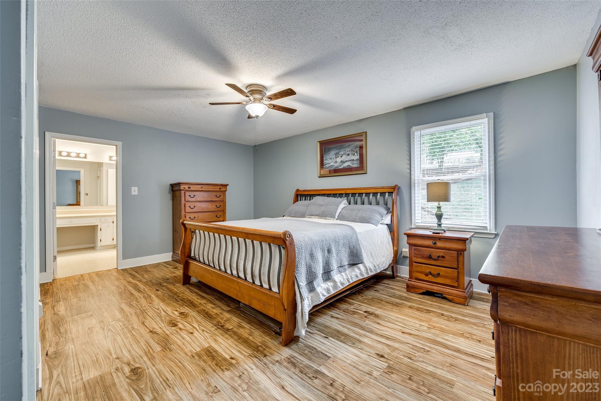 16064 Taku Court Tega Cay, SC 29708 - Photo 16 of 31 a spacious bedroom with a bed and a table in it