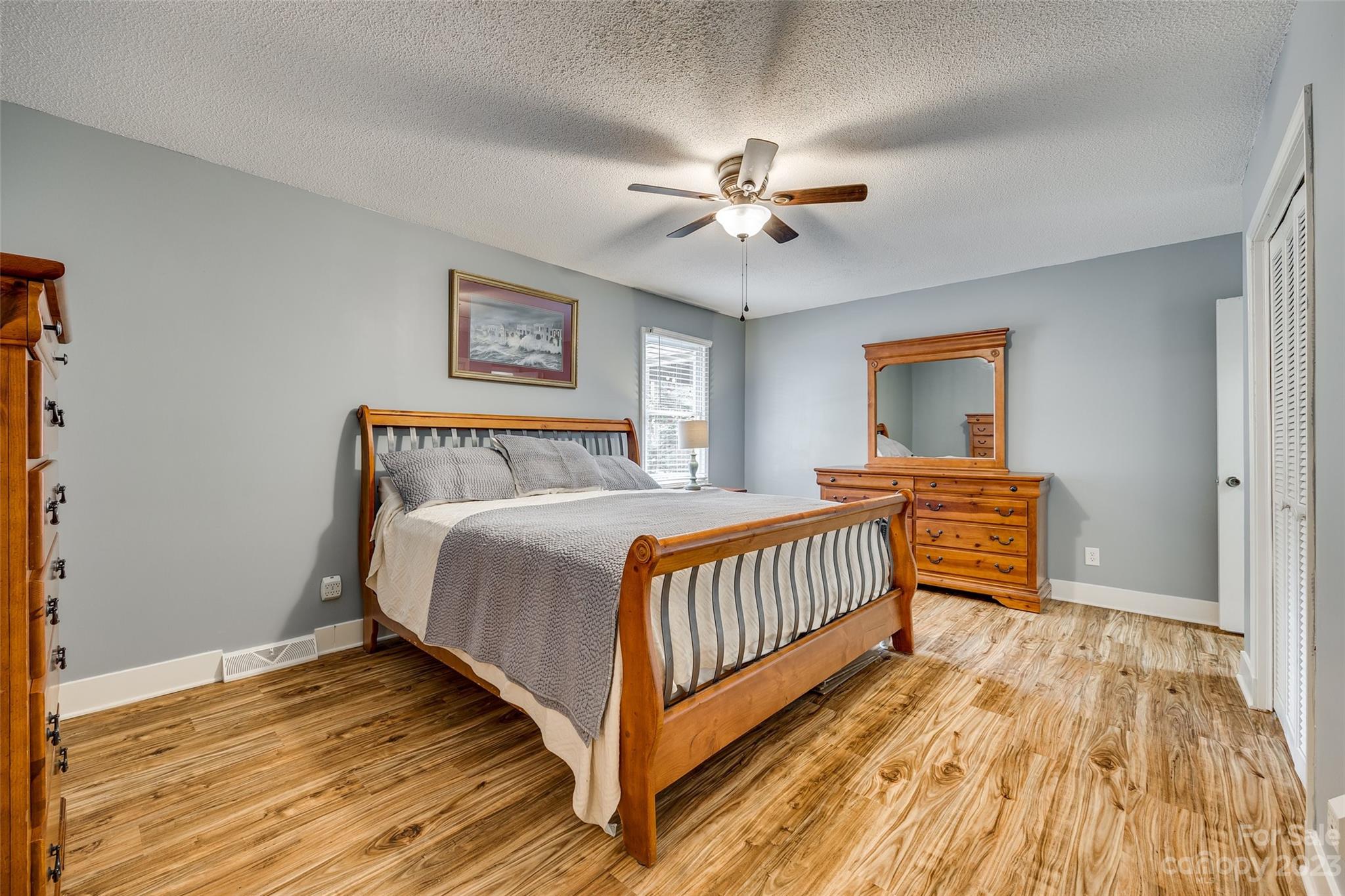16064 Taku Court Tega Cay, SC 29708 - Photo 18 of 31 a bedroom with a bed and a chandelier