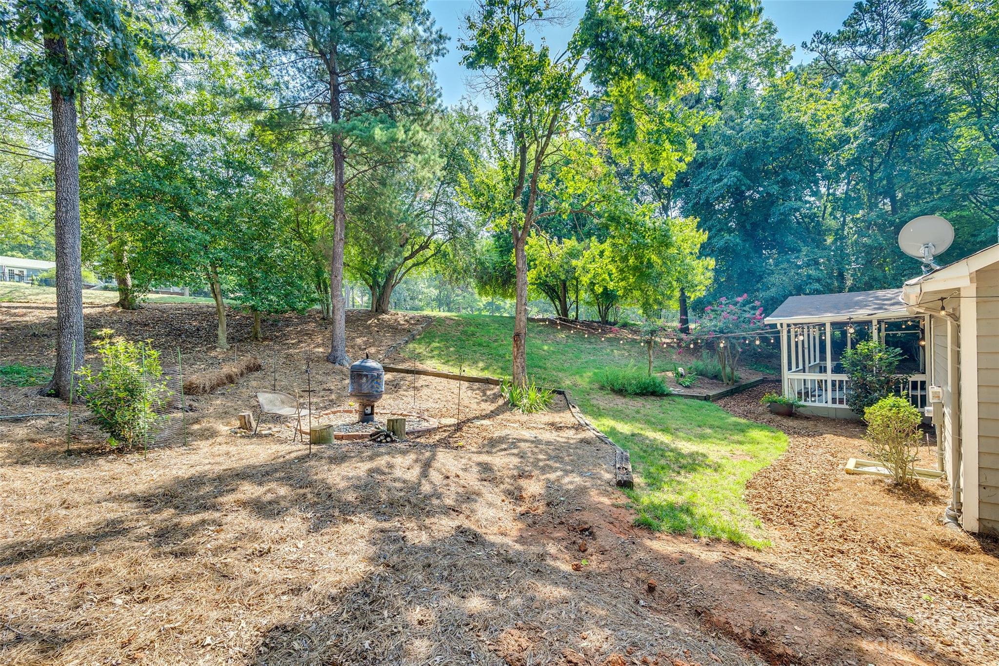 16064 Taku Court Tega Cay, SC 29708 - Photo 30 of 31 a view of a yard with plants and a table and chair
