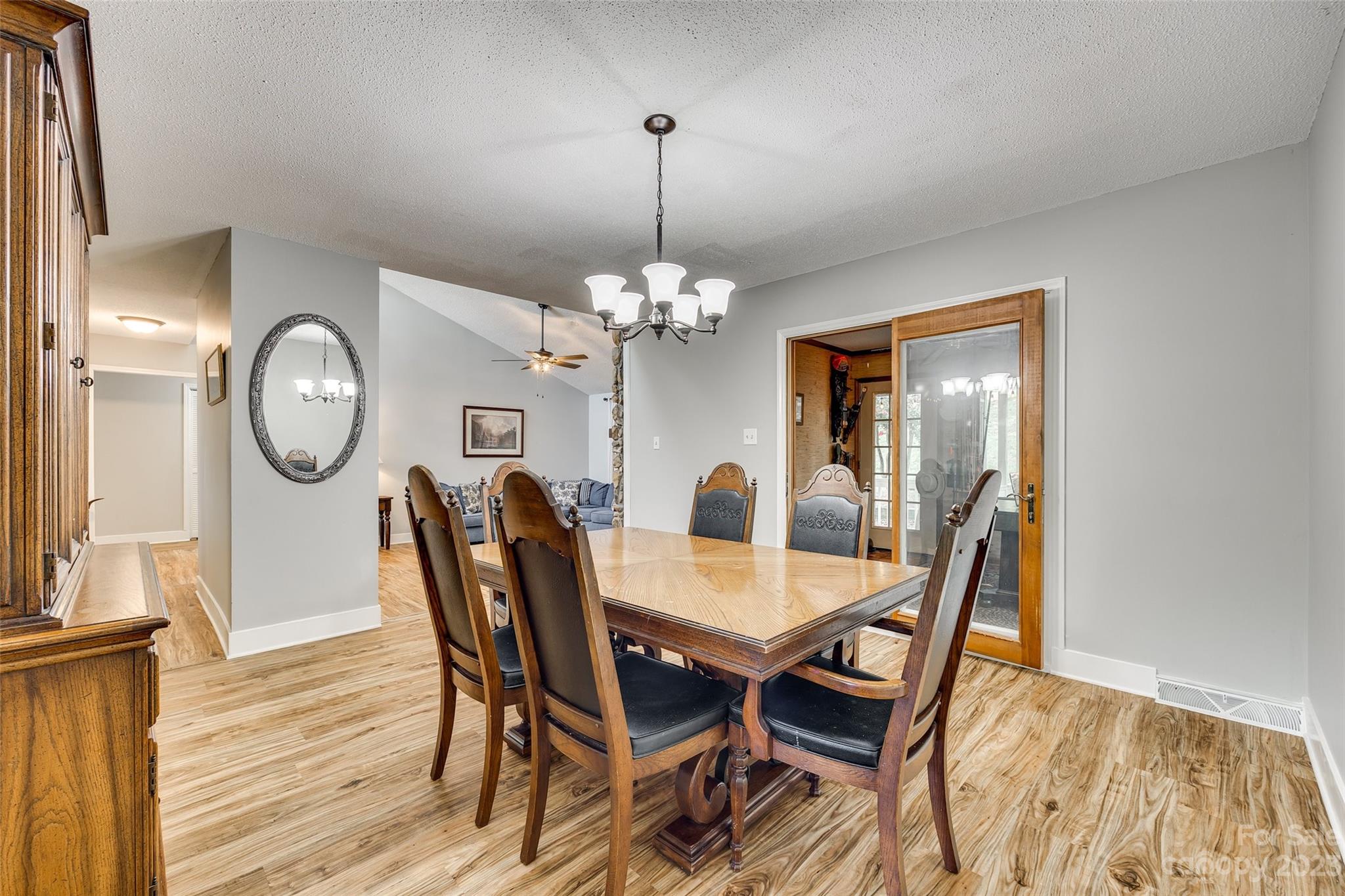 16064 Taku Court Tega Cay, SC 29708 - Photo 8 of 31 a dining room with furniture a mirror and wooden floor