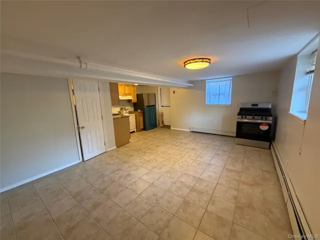 a view of a kitchen with a stove cabinets and a window