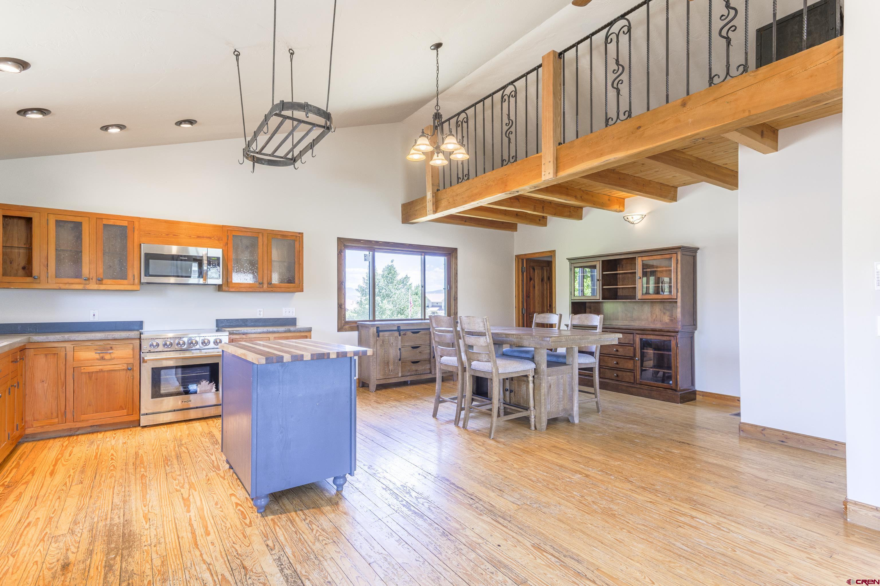 388 Columbine Road Gunnison, CO 81230 - Photo 17 of 45 a view of a dining room with furniture window and wooden floor