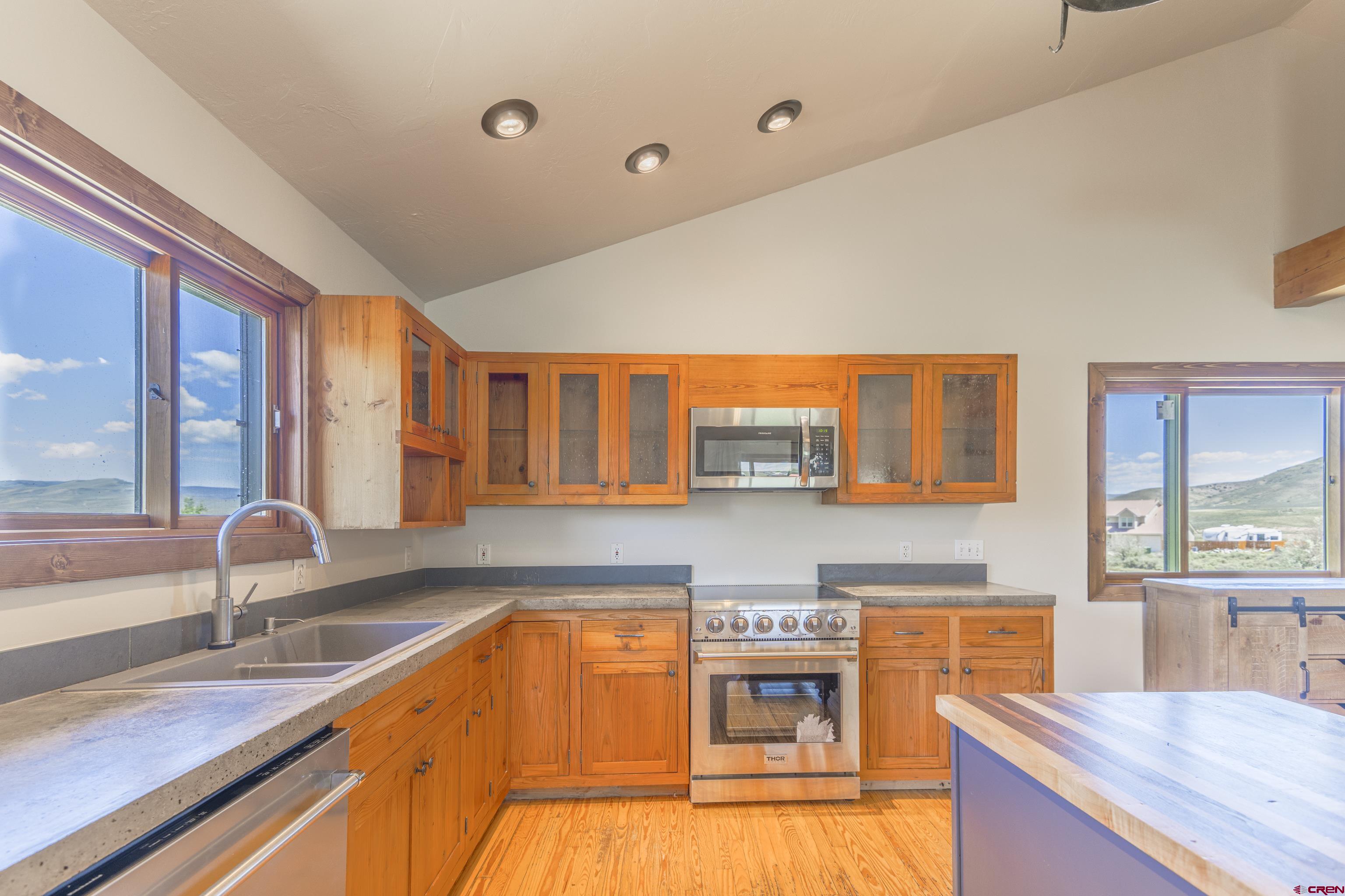 388 Columbine Road Gunnison, CO 81230 - Photo 18 of 45 a kitchen with stainless steel appliances granite countertop a sink and a stove