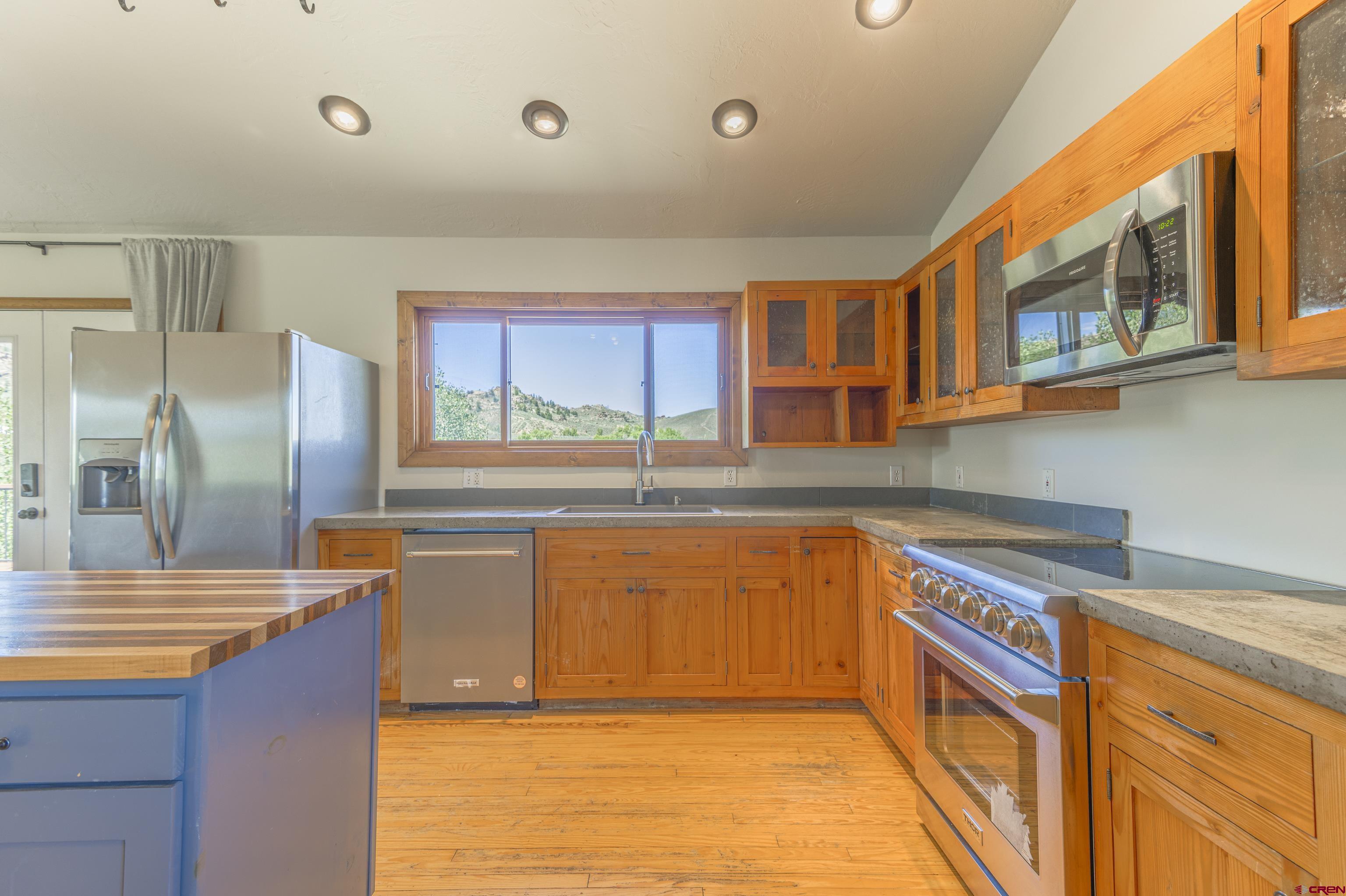 388 Columbine Road Gunnison, CO 81230 - Photo 19 of 45 a kitchen with stainless steel appliances granite countertop a sink and a refrigerator
