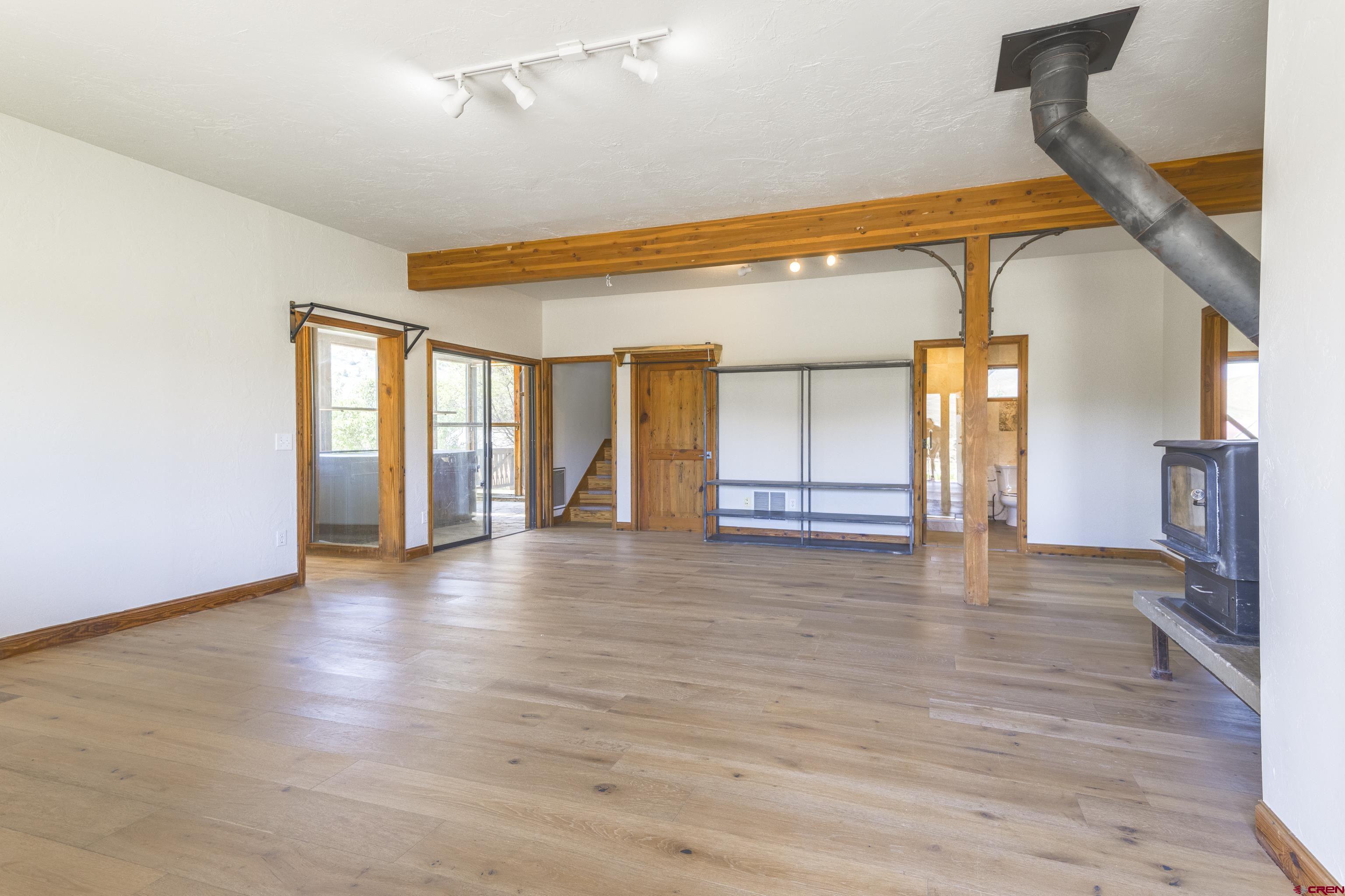 388 Columbine Road Gunnison, CO 81230 - Photo 2 of 45 a view of an empty room with window and wooden floor