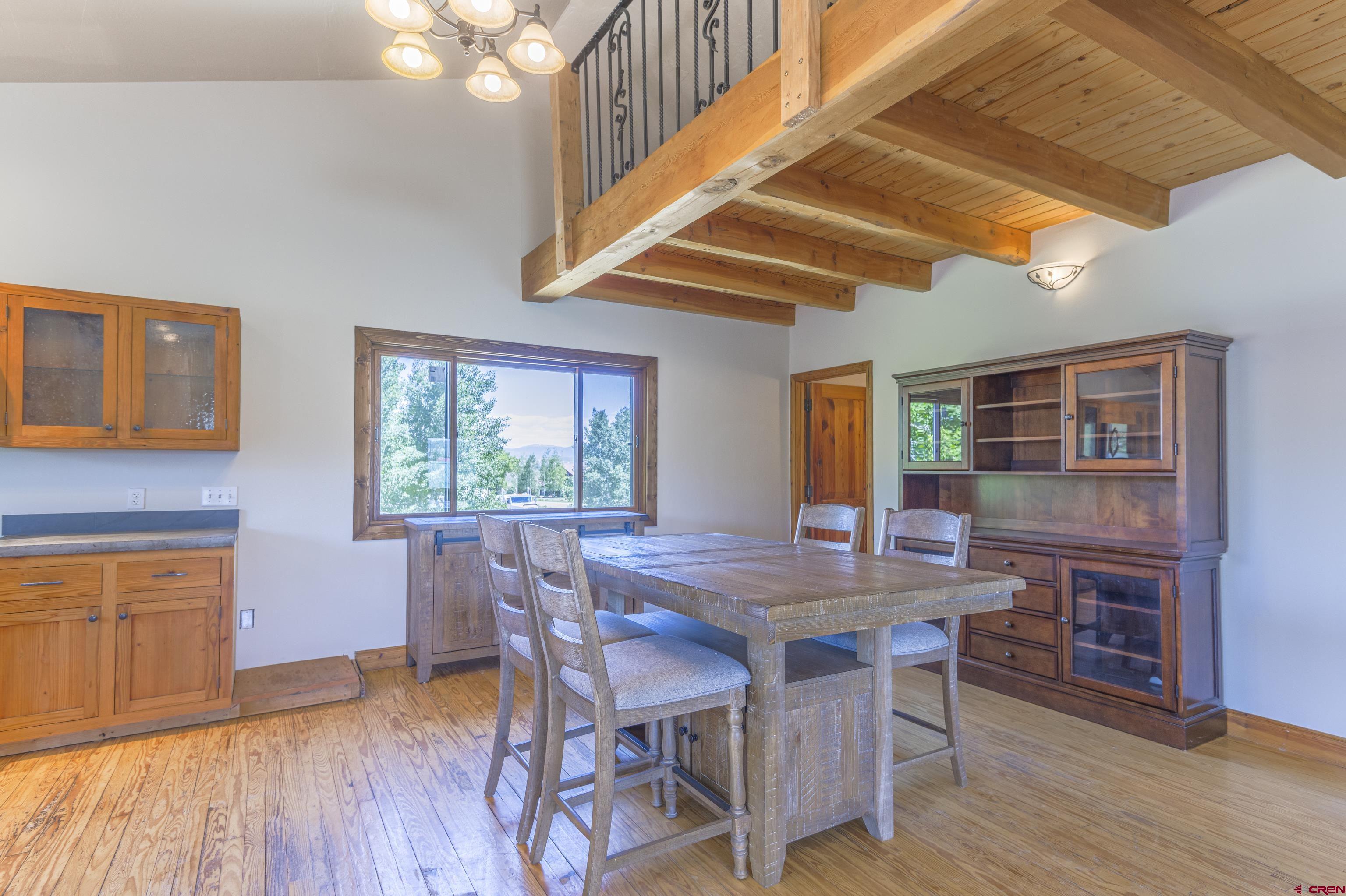 388 Columbine Road Gunnison, CO 81230 - Photo 24 of 45 a view of a dining room with furniture window and wooden floor
