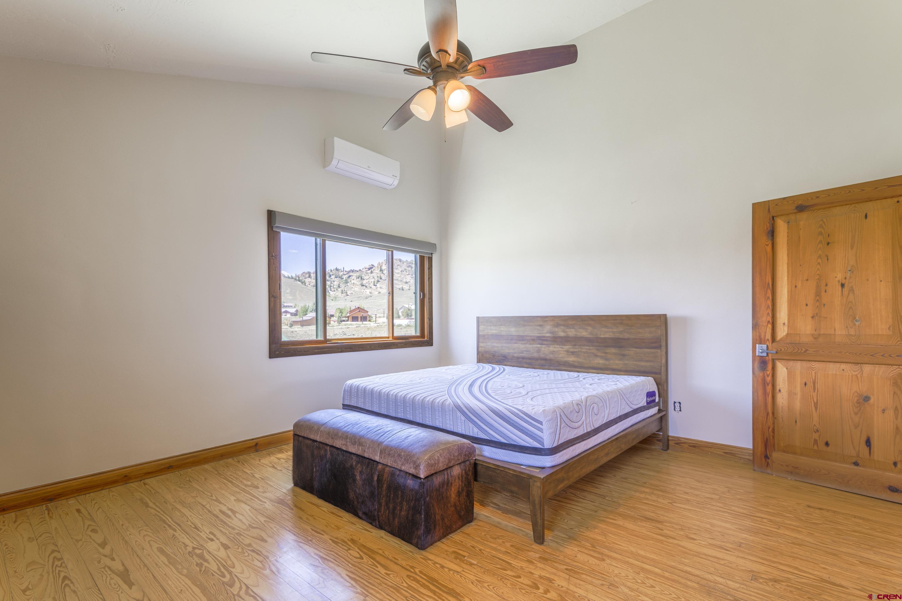 388 Columbine Road Gunnison, CO 81230 - Photo 26 of 45 a bedroom with a bed and a window
