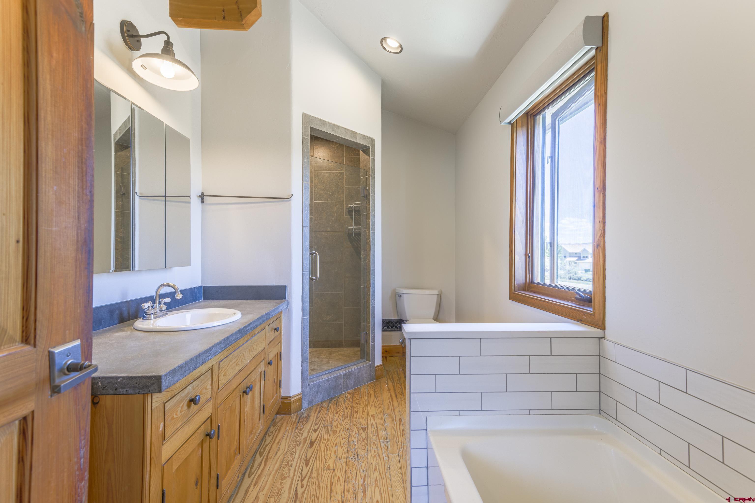 388 Columbine Road Gunnison, CO 81230 - Photo 28 of 45 a bathroom with a sink a mirror and a bathtub