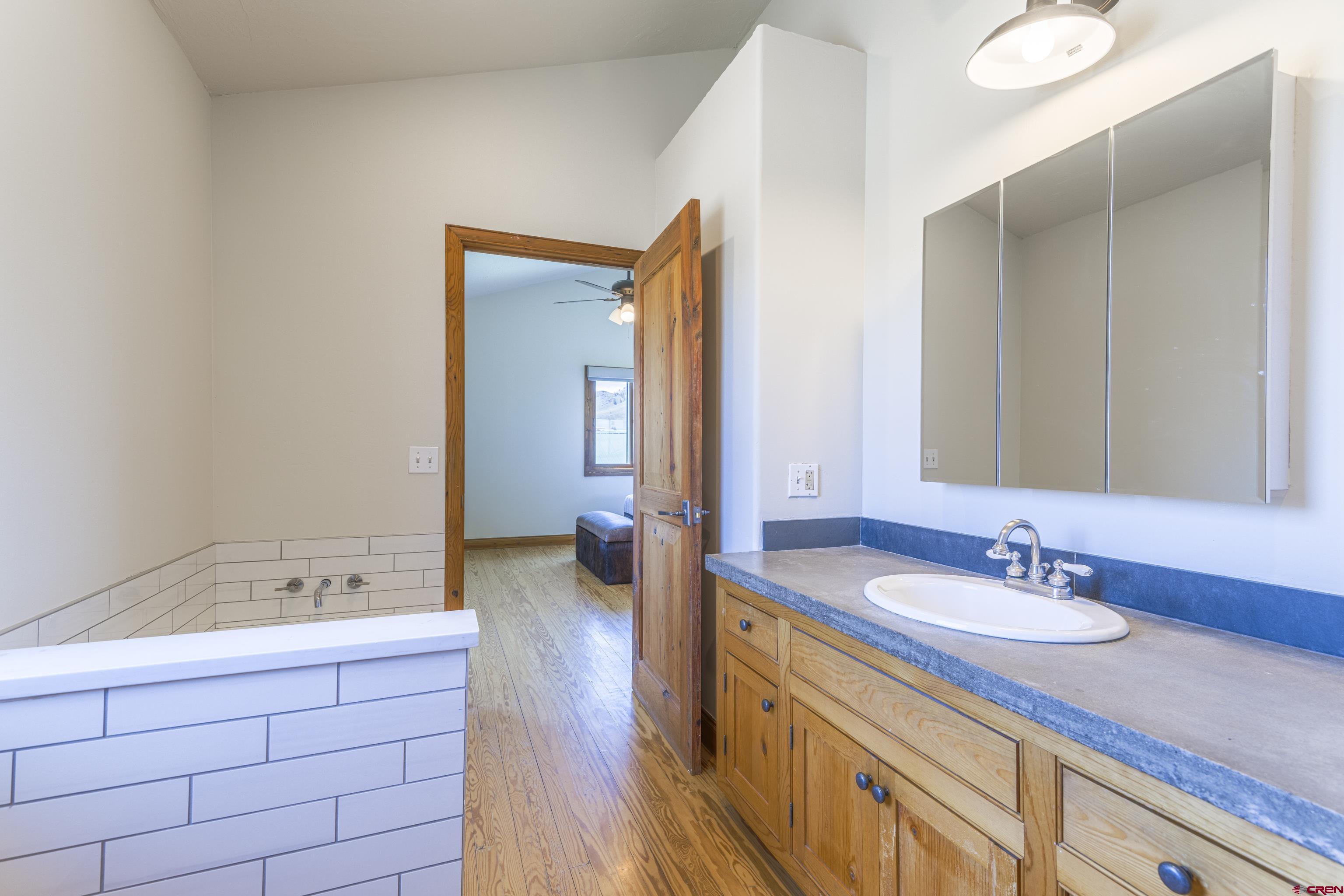 388 Columbine Road Gunnison, CO 81230 - Photo 29 of 45 a bathroom with a sink double vanity and a mirror