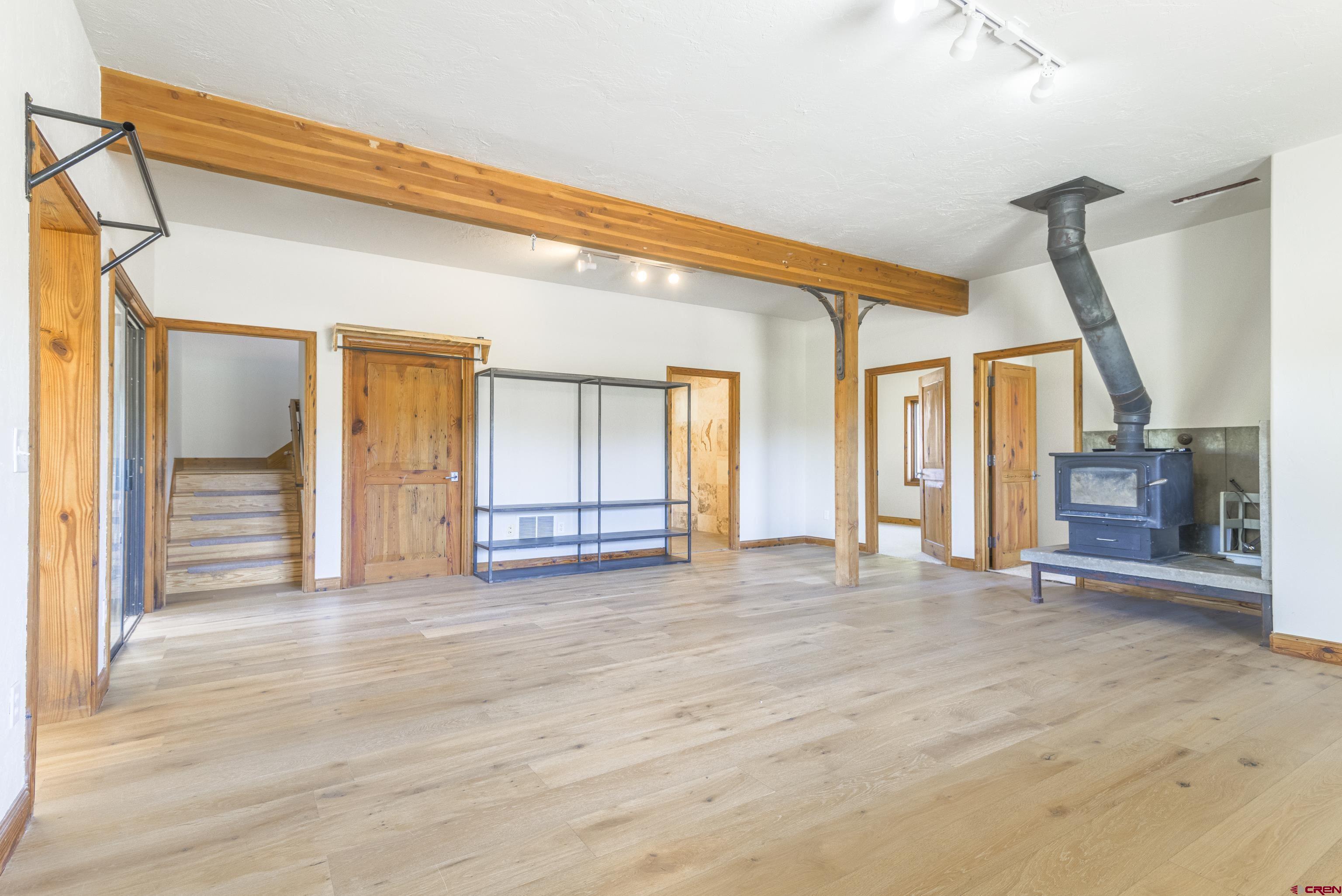 388 Columbine Road Gunnison, CO 81230 - Photo 3 of 45 a view of a livingroom with wooden floor and stairs