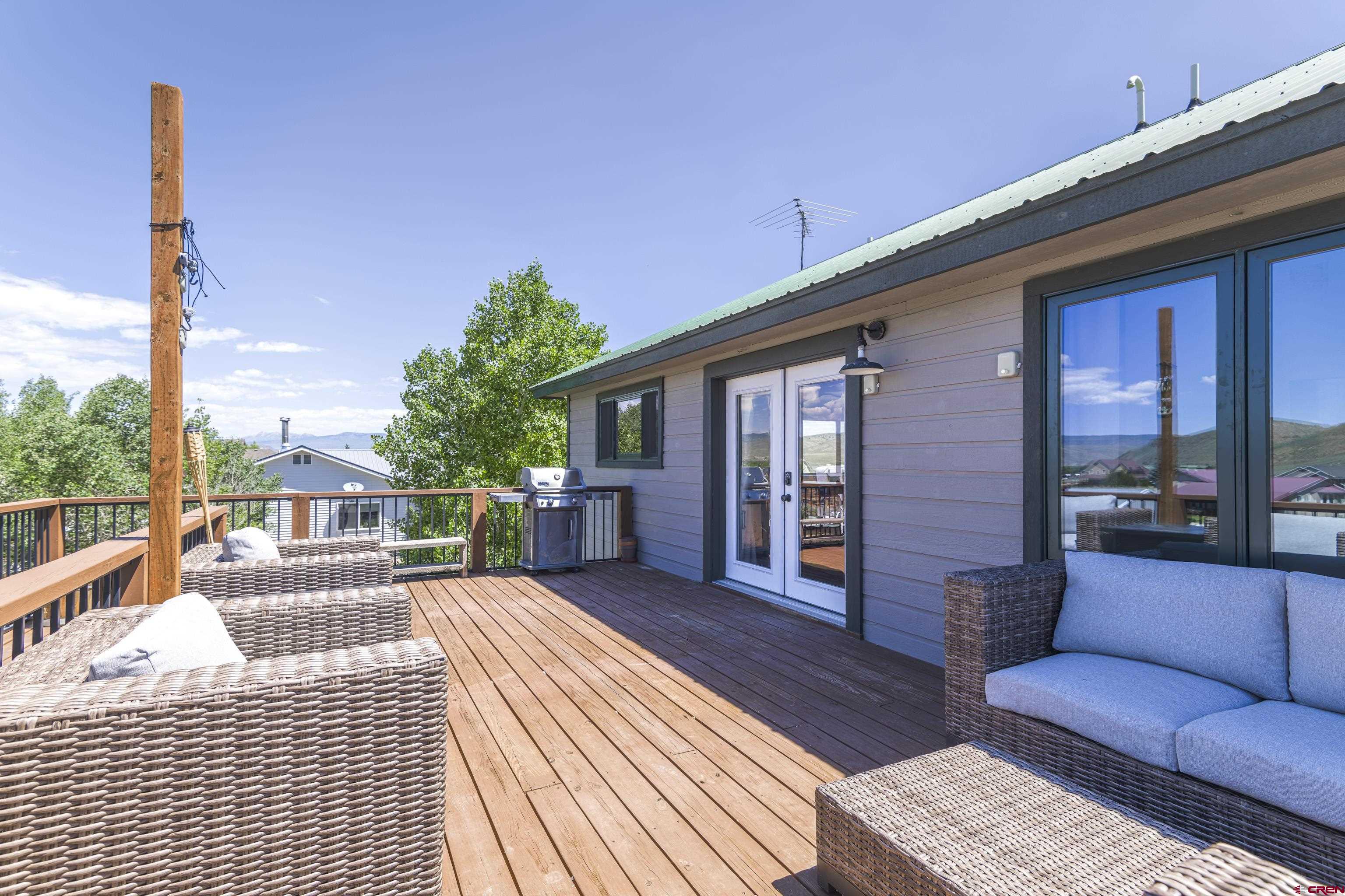 388 Columbine Road Gunnison, CO 81230 - Photo 31 of 45 a view of a house with couches chairs and wooden floor