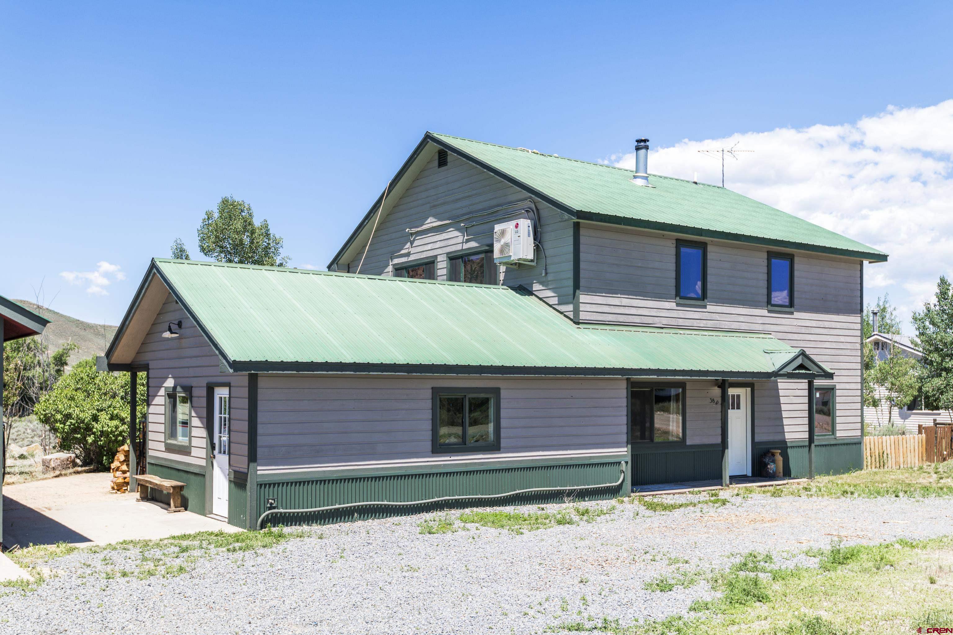 388 Columbine Road Gunnison, CO 81230 - Photo 32 of 45 a front view of a house with a yard and garage