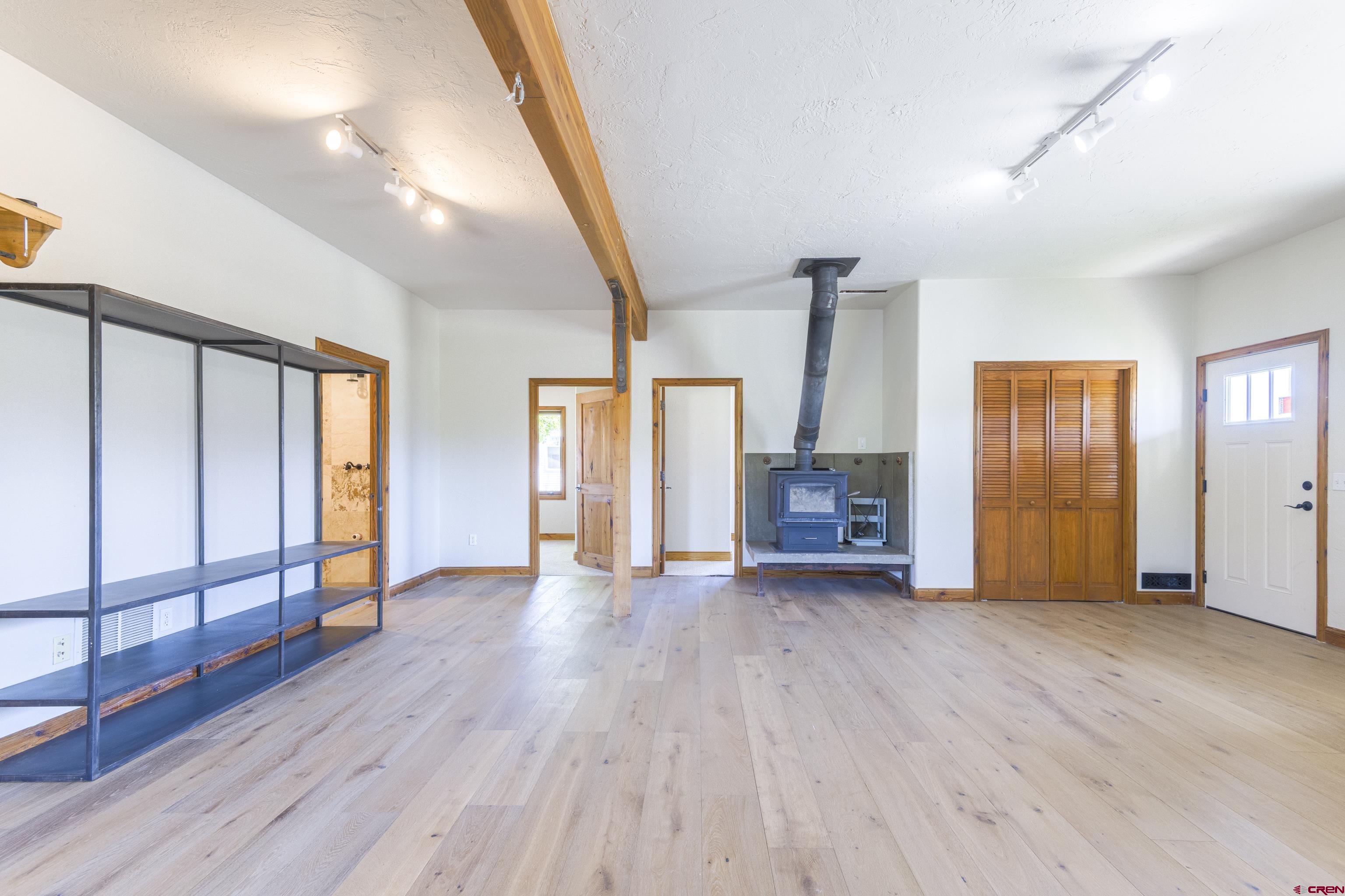 388 Columbine Road Gunnison, CO 81230 - Photo 4 of 45 an empty room with wooden floor and windows