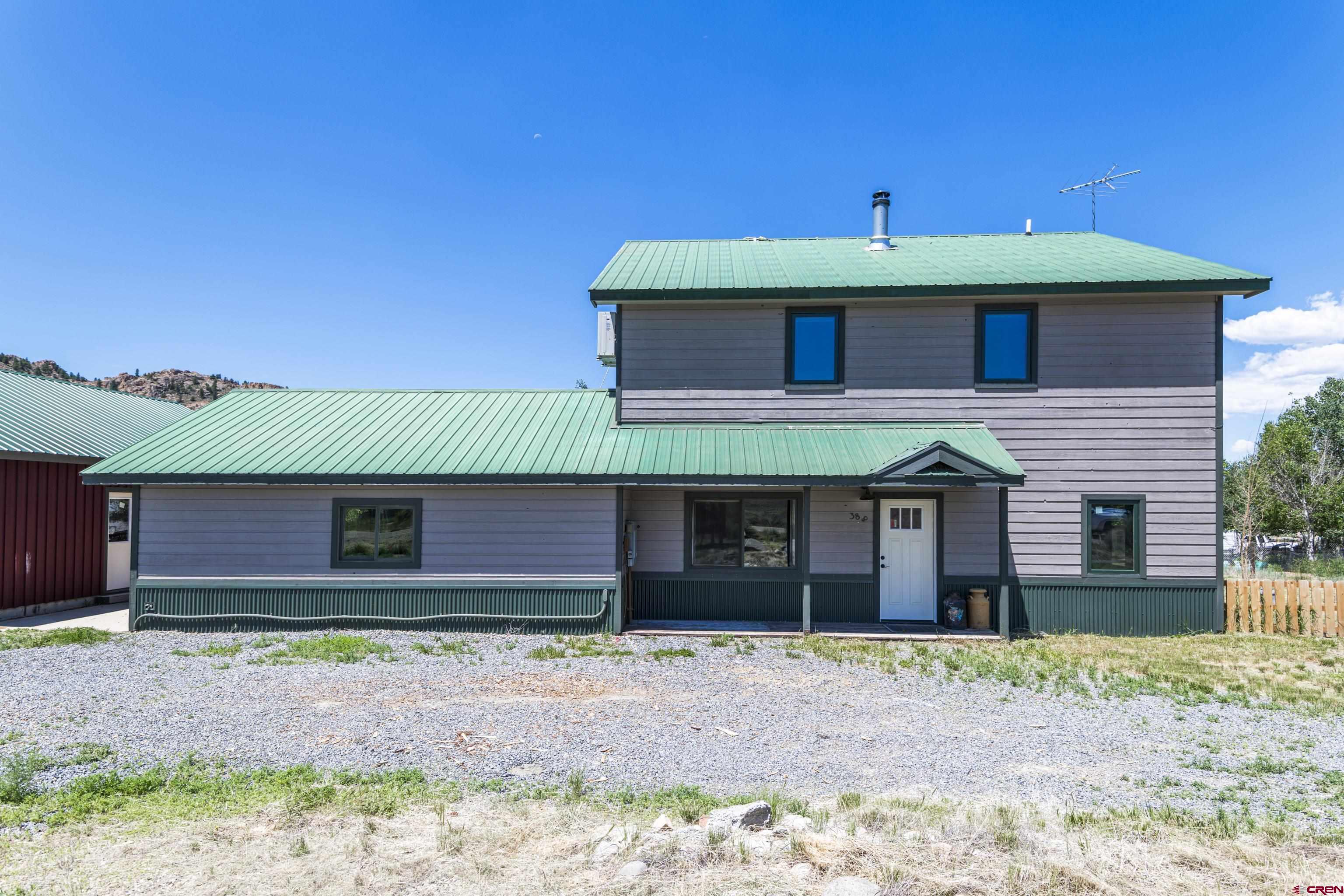 388 Columbine Road Gunnison, CO 81230 - Photo 41 of 45 a front view of a house with a yard and a garage