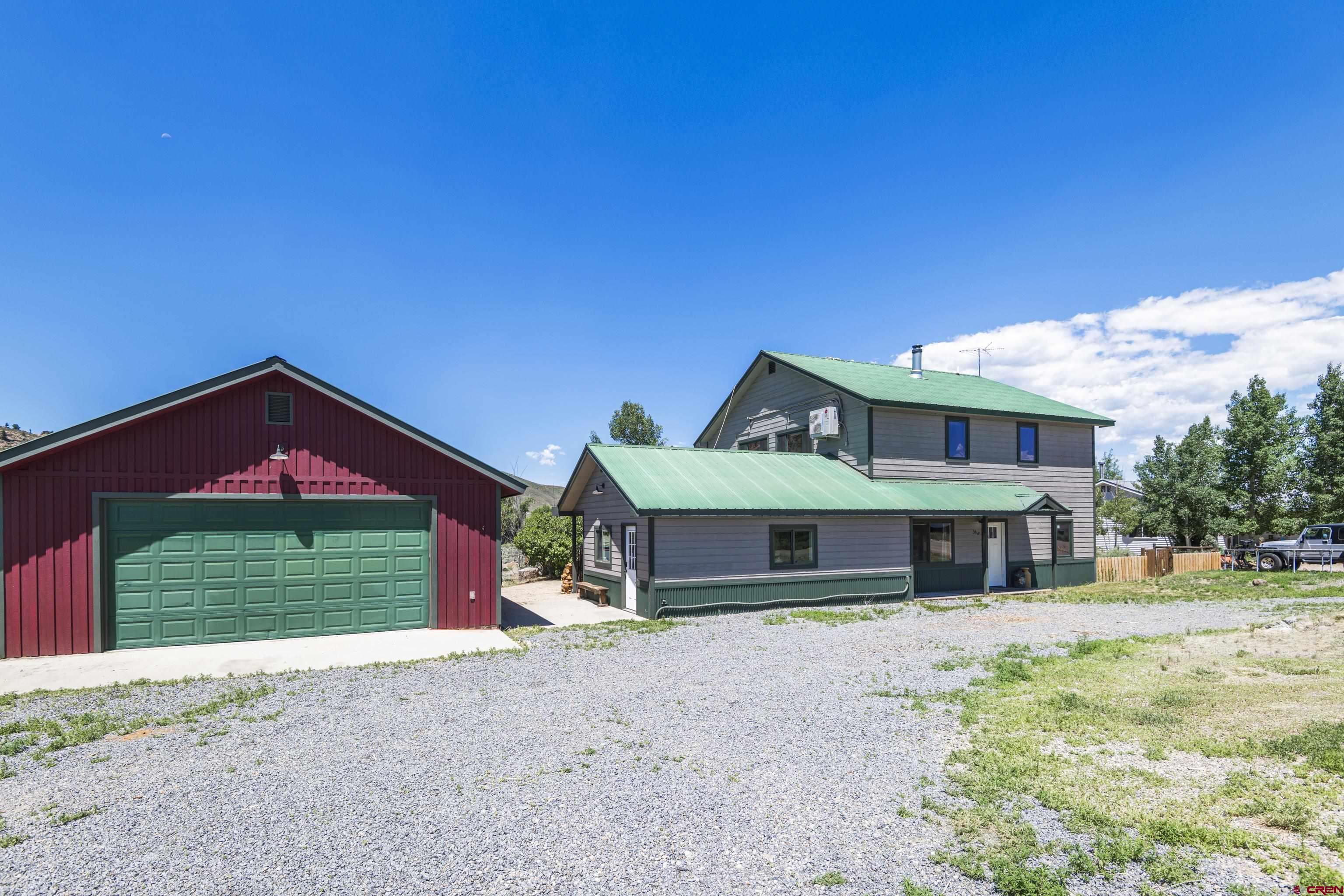 388 Columbine Road Gunnison, CO 81230 - Photo 42 of 45 a front view of a house with a yard and garage